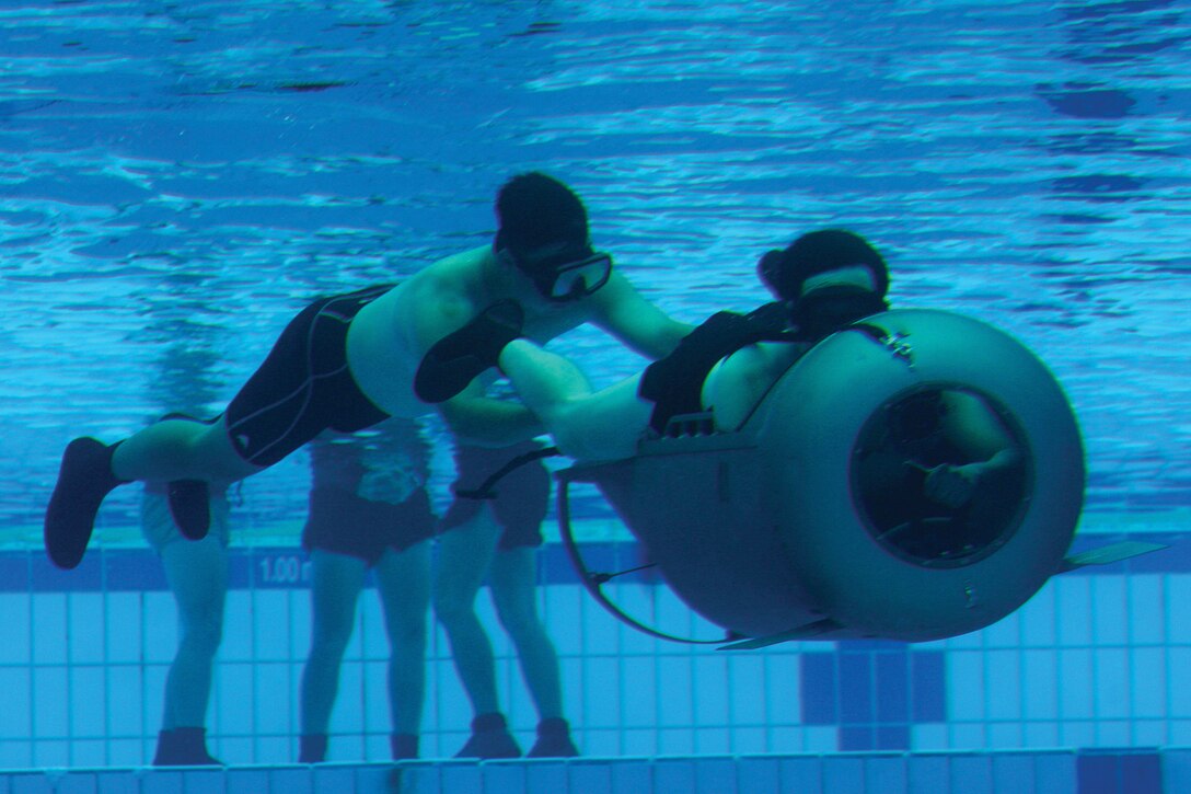 Members of the Singapore Armed Forces Naval Diving Unit operate a diver-propulsion device in a training pool on Sembawang Camp in the Republic of Singapore Jan. 12. Marines with Company A, 3rd Reconnaissance Battalion, brought the devices to the Republic of Singapore to support Exercise Sandfisher a bilateral training exercise conducted to increase interoperability. 3rd Recon Bn. is part of 3rd Marine Division, III Marine Expeditionary Force.