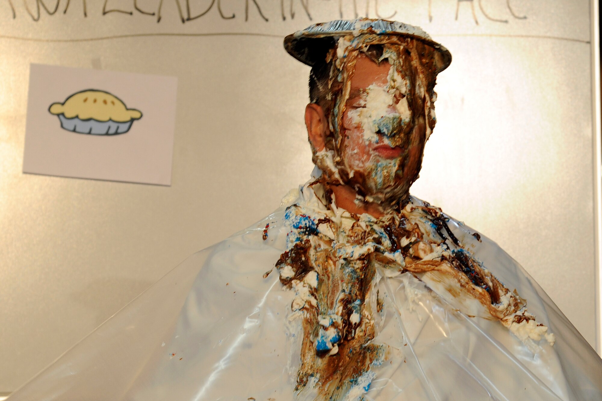 MISAWA AIR BASE, Japan - Chief Master Sgt. Russell Hastings, 35th Fighter Wing command chief, takes a pie in the face during the annual awards banquet "pie-in-the-face" fundraiser event here, Jan 10. Hastings was the top fundraiser, raising more than $350, and was named the 2011 "Misawa Air Base Pie Commander." (U.S. Air Force photo/Tech. Sgt. Marie Brown)