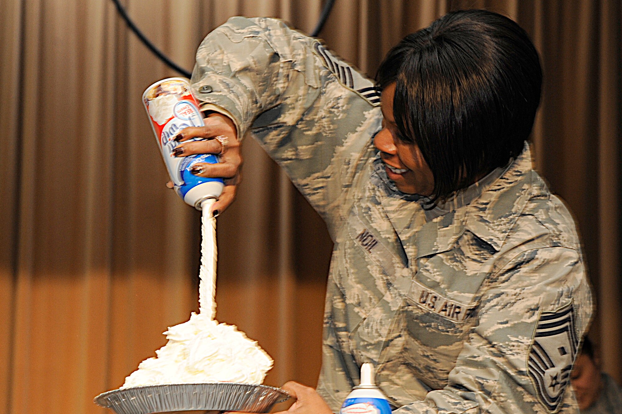 MISAWA AIR BASE, Japan - Chief Master Sgt. Felica Noil, 35th Maintenance Squadron first sergeant, makes a whipped-cream pie with sprinkles and chocolate syrup that was used to pie a Misawa leader in the face during the annual awards banquet "pie-in-the-face" fundraiser here, Jan. 10. More than $3,000 were raised through the fundraiser, with proceeds going back to the local community to help support the awards banquet in February. (U.S. Air Force photo/Tech. Sgt. Marie Brown)