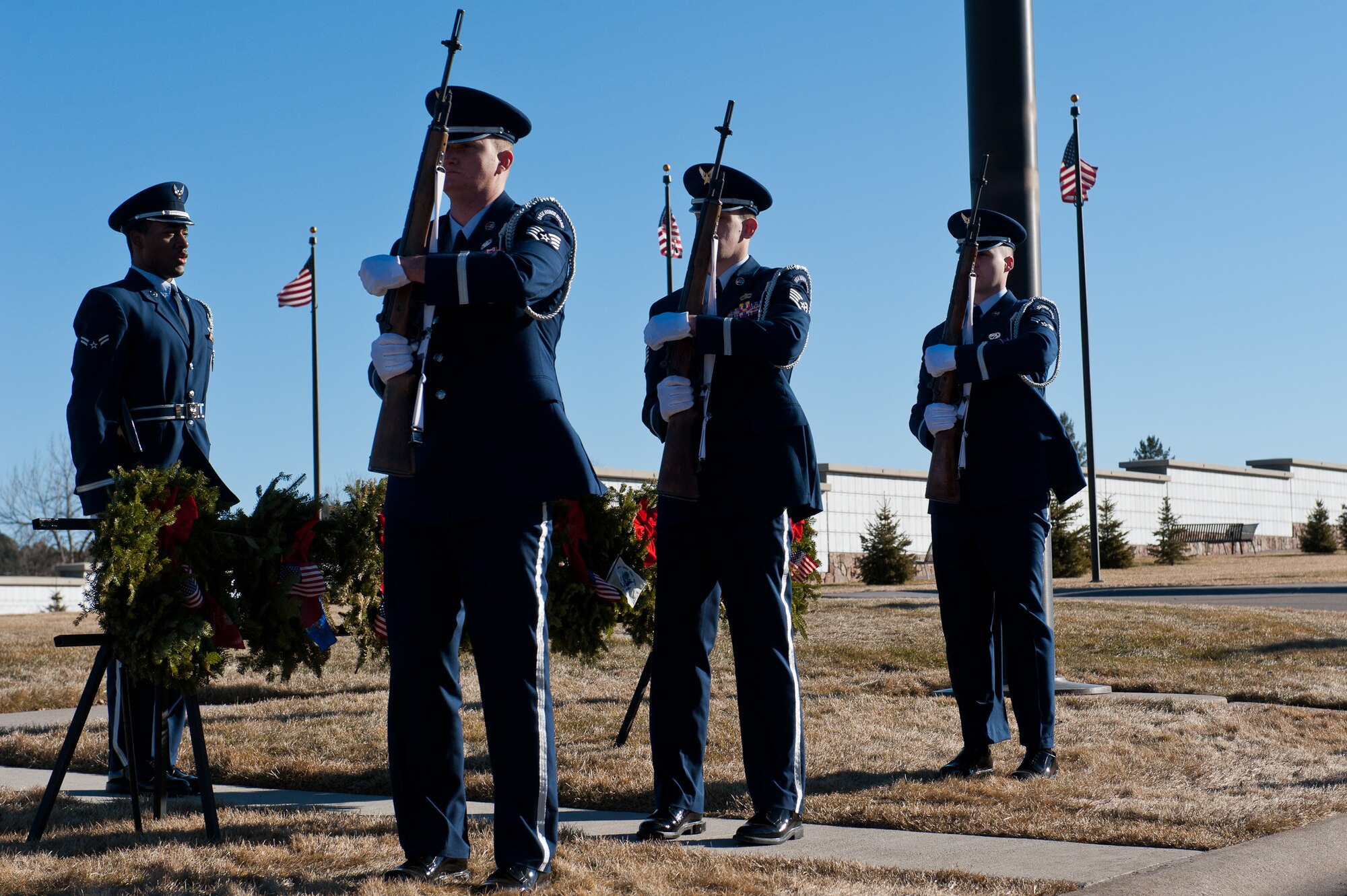 Airmen of the Ellsworth Air Force Base Honor Guard firing party charge their weapons on command during a funeral at the Black Hills National Cemetery near Sturgis, S.D., Jan. 6 2012. The firing party posts outside and fires three volleys to honor the fallen military servicemember. (U.S. Air Force photo by Airman 1st Class Kate Thornton/Released)