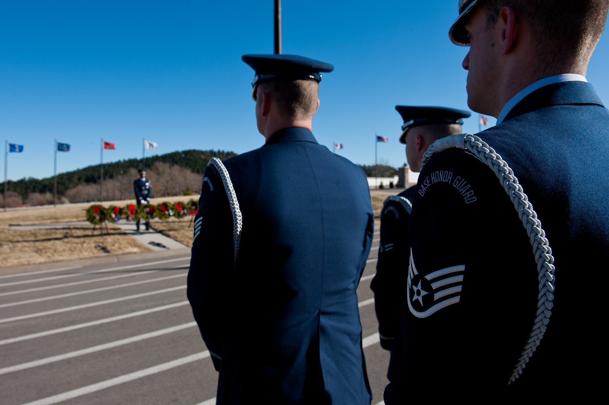Airmen of the Ellsworth Air Force Base Honor Guard await the arrival of a deceased U.S. military retiree during a funeral at the Black Hills National Cemetery near Sturgis, S.D., Jan. 6, 2012. The Base Honor Guard is responsible for providing military honors throughout a 114,636 square mile area covering South Dakota, western Nebraska and northern Wyoming.  (U.S. Air Force photo by Airman 1st Class Kate Thornton/Released)