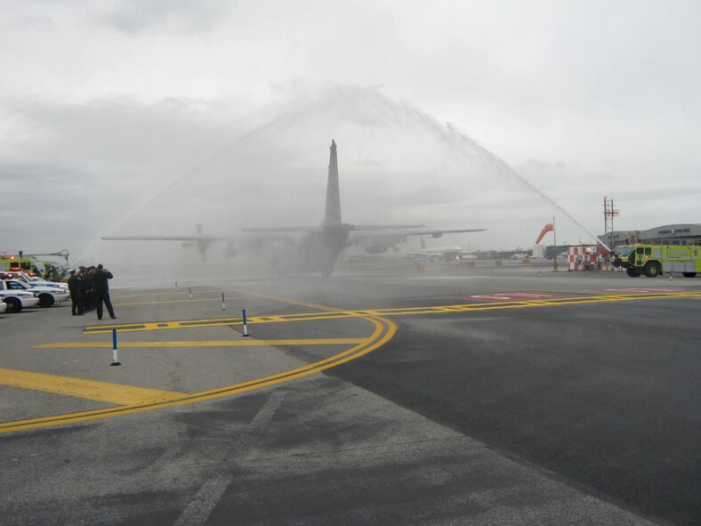 Airport employees and members of the Port Authority of New York and New Jersey welcome the crew of an AC-130 Spectre Gunship Dec 28, 2011.  The AC-130 was diverted to LaGuardia Airport, New York City, NY, where the crewmembers were met with a surprise hero's welcome. (Photo courtesy of the Port Authority of New York and New Jersey)