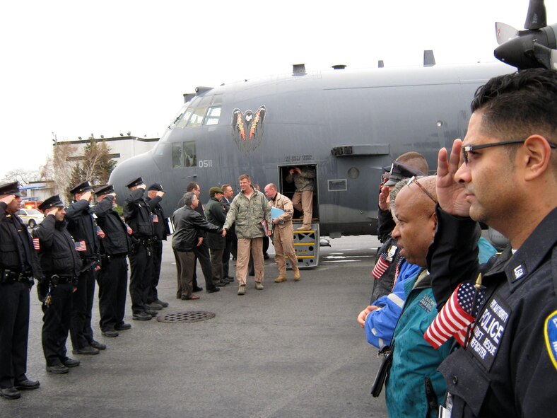 Airport employees and members of the Port Authority of New York and New Jersey welcome the crew of an AC-130 Spectre Gunship Dec 28, 2011.  The AC-130 was diverted to LaGuardia Airport, New York City, NY, where the crewmembers were met with a surprise hero's welcome. (Photo courtesy of the Port Authority of New York and New Jersey)
