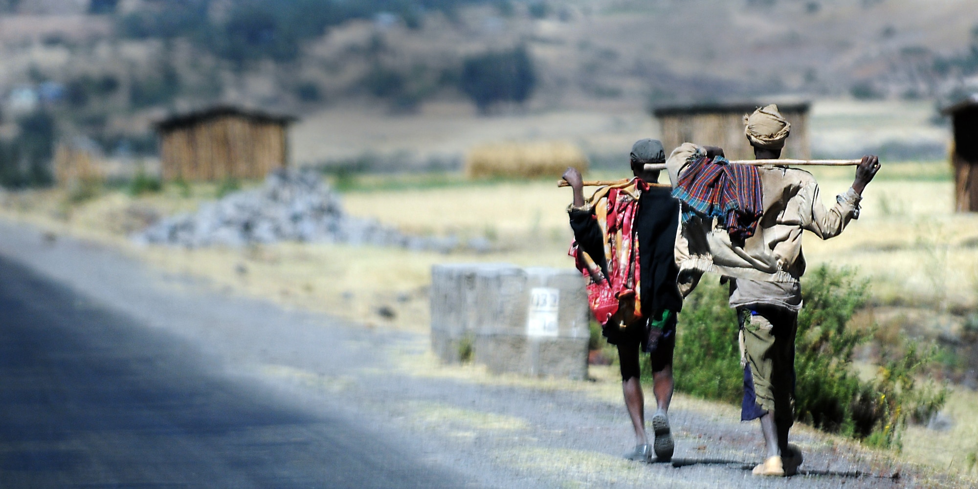 Two men walk along the road to Addis Ababa, Ethiopia, Dec. 8, 2011. People in Ethiopia may choose to leave their rural homes and walk to the cities to seek work. (U.S. Air Force photo/Senior Airman Jarad Denton)