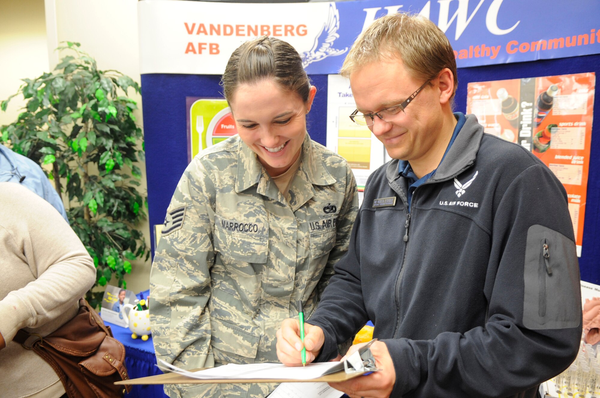 VANDENBERG AIR FORCE BASE, Calif. – Morten Zederkof, the Health and Wellness Center’s events program manager, signs up Staff Sgt. Lacey Marrocco, member of the 30th Logistics Readiness Squadron, to participate in the Lose to Win competition at the 30th Medical Group here Monday, Jan. 9, 2012. Lose to Win is a 12-week program offered as a motivating and effective way to achieve weight loss. (U.S. Air Force photo/Tech. Sgt. Scottie McCord) 