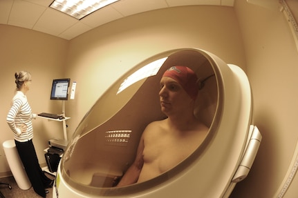 Lorri Tibbetts, Health Promotions Manager at the Joint Base San Antonio-Randolph Health and Wellness Center performs body fat measurements for Staff Sgt Michael Blunt, Air Force Recruiting Service, in the Bod Pod Jan. 10. The Bod Pod is the latest technology in body fat measurement. (U.S. Air Force photo/Rich McFadden) (released)