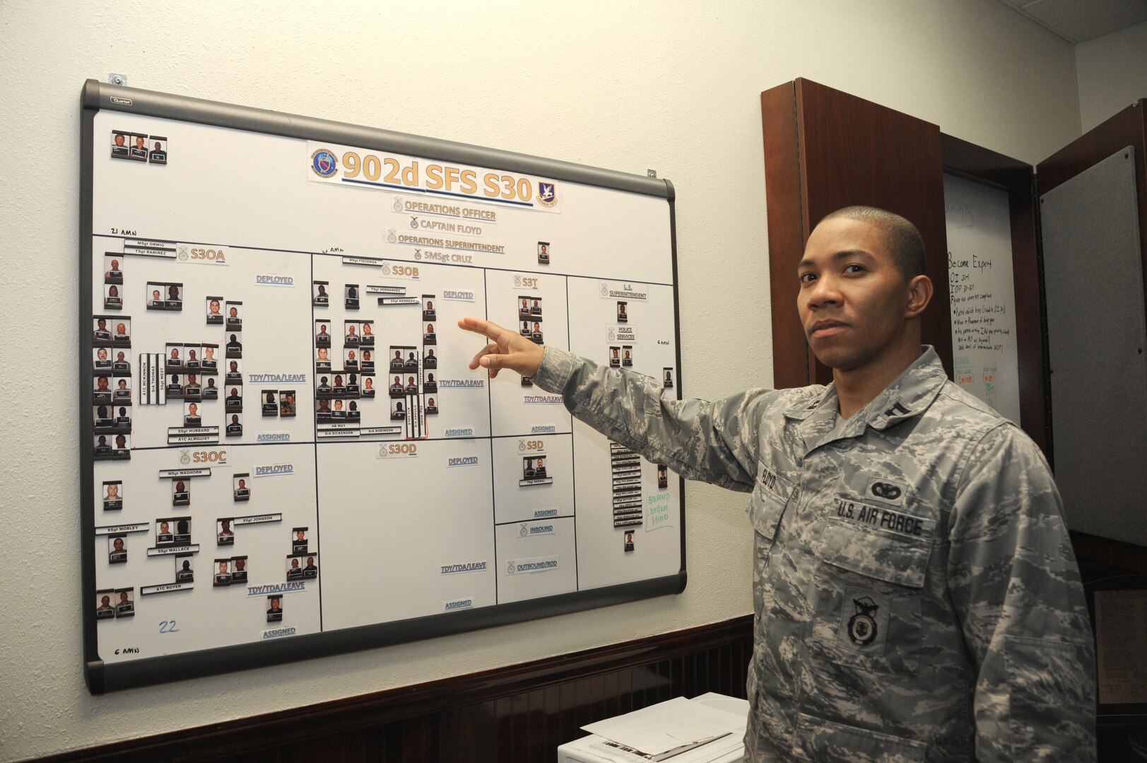 Capt. Antwan Floyd, 902nd Security Forces Squadron, demonstrates the use of his scheduling board in his office on Joint Base San Antonio-Randolph Jan. 9.  The 902nd SFS has recently transitioned from 12- to eight-hour shifts. (U.S. Air Force photo/Rich McFadden) (released)