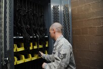 Staff Sgt Johnathan Kuenzli, 902nd Security Forces Squadron, inventories weapons in the armory on Joint Base San Antonio-Randolph Jan. 9.  The 902nd SFS has recently transitioned from 12- to eight-hour shifts. (U.S. Air Force photo/Rich McFadden) (released)