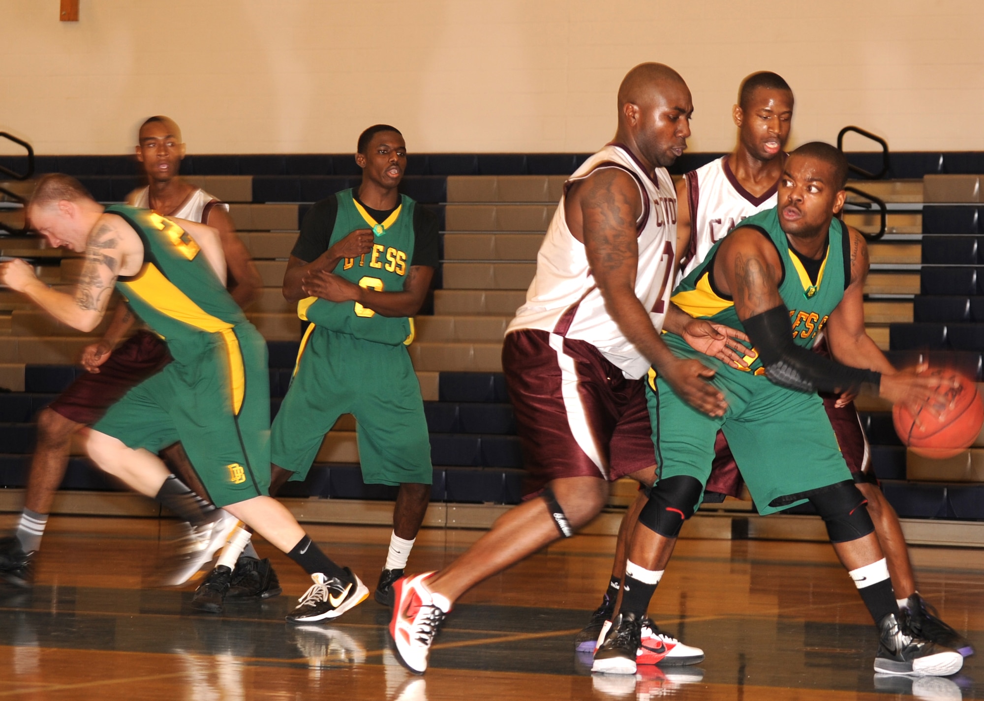 U.S. Air Force Staff Sgt. Torin Walter, 27th Special Operations Logistics Readiness Squadron, and Staff Sgt. James Dexter, 27th Special Operations Civil Engineer Squadron, guard a player from Dyess Air Force Base, Texas, in the Fitness Center at Cannon Air Force Base, N.M., Jan.7, 2011. Cannon won their first home-game 72-68, besting Dyess Air Force Base, Texas. (U.S. Air Force photo by Airman 1st Class Alexxis Pons Abascal)
