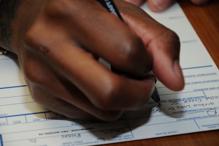 Information required on the Standard Form 87 fingerprint card includes the location of tattoos, piercings and scars along with basic information such as height, weight and Social Security number. Once the card is filled out, fingerprints are then placed directly on the card. All fingerprints are then entered into the Federal Bureau of Investigation’s data base to determine if there are any outstanding warrants on the service member. (U.S. Navy photo/Petty Officer 1st Class Jennifer Hudson)