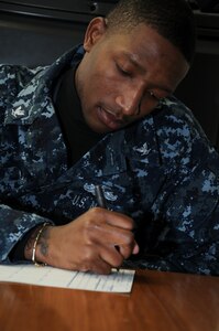 Petty Officer Third Class Ryan Davis, originally from Orangeburg, S.C., fills out a Standard Form 87 fingerprint card with pertinent information prior to getting his fingerprints taken for a security clearance. Ship’s Serviceman Davis reported to Joint Base Charleston-Weapons Station Dec. 12, 2011 and is working at Unaccompanied Personnel Housing. (U.S. Navy photo/ Mass Communication Specialist 1st Class Jennifer Hudson)