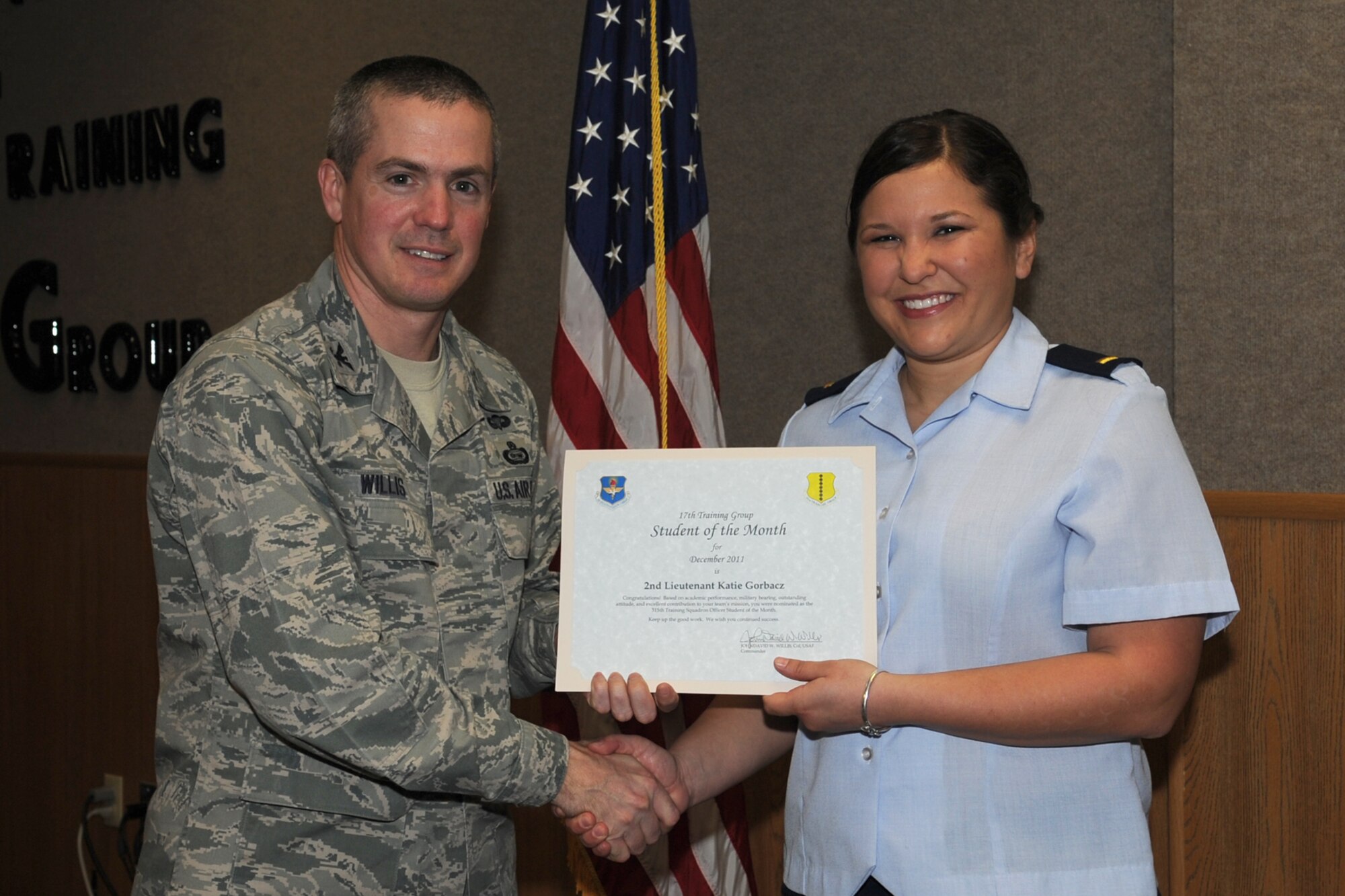 GOODFELLOW AIR FORCE BASE, Texas -- Col. JD Willis, 17th Training Group Commander, presents 2nd Lt. Katie Gorbacz with the 315th Training Squadron Officer Student of the Month award for December, Jan. 6. (U.S. Air Force photo/Staff Sgt. Laura R. McFarlane)