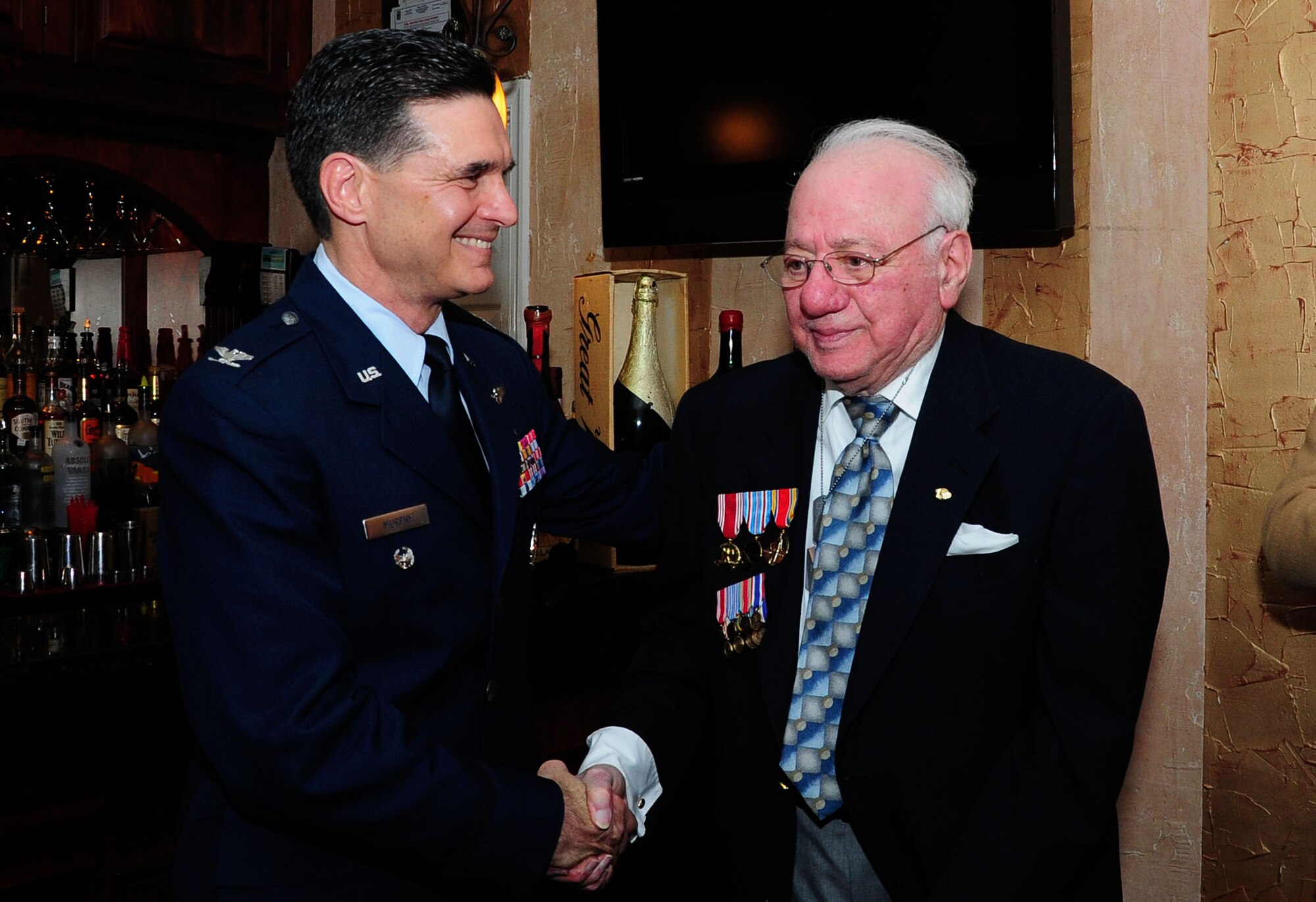 WASHINGTON -- Eugene M. Narsete, M.D., shakes hands with Col. Sean Murphy, Deputy Assistant Surgeon General for Healthcare Operations (AFMS), during a presentation of long overdue medals at a dinner celebrating Narsete’s 90th birthday here, Jan. 7, 2012. Narsete received the Army Good Conduct Medal, American Campaign Medal and the World War II Victory Medal in addition to commemorative medals, presented by his family, for his military service between 1943 - 1948. (U.S. Air Force photo/Staff Sgt. Tiffany Trojca)  