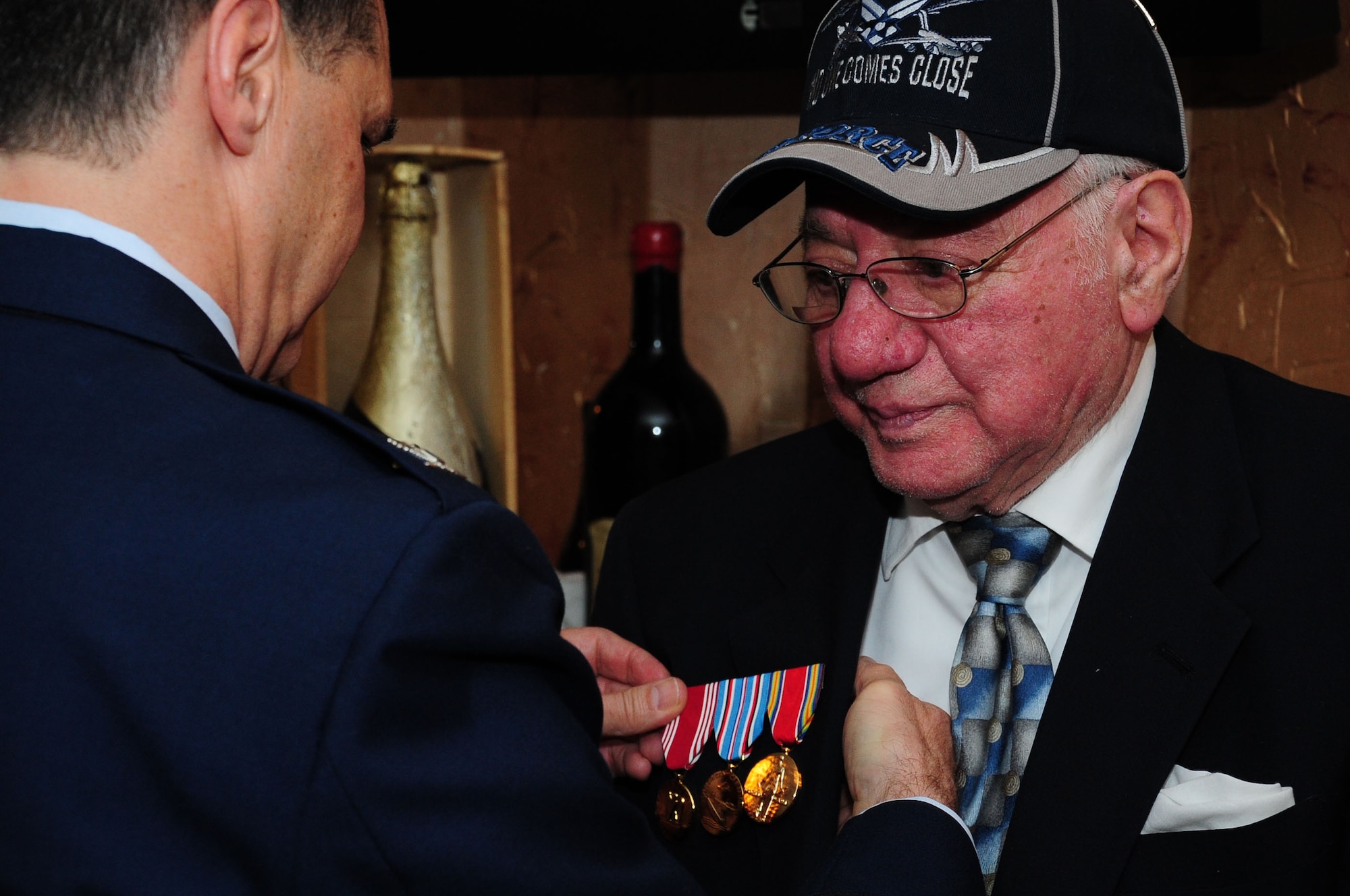 WASHINGTON -- Eugene M. Narsete, M.D., is presented the Army Good Conduct Medal, American Campaign Medal and the World War II Victory Medal by Col. Sean Murphy, Deputy Assistant Surgeon General for Healthcare Operations, during a dinner celebrating Narsete’s 90th birthday here, Jan 7, 2012. Narsete performed duty within the continental United States for one year during WWII as a private first class. He then attended medical school at Loyola University with the promise he would return to serve as a doctor in the U.S. Armed Forces. After he received his medical degree he accepted a commission and Headquarters Army Air Forces in Washington D.C. and named Capt. Narsete as an Aviation Medical Officer in 1946. Narsete never received his medals during his career. (U.S. Air Force photo/Staff Sgt. Tiffany Trojca) 