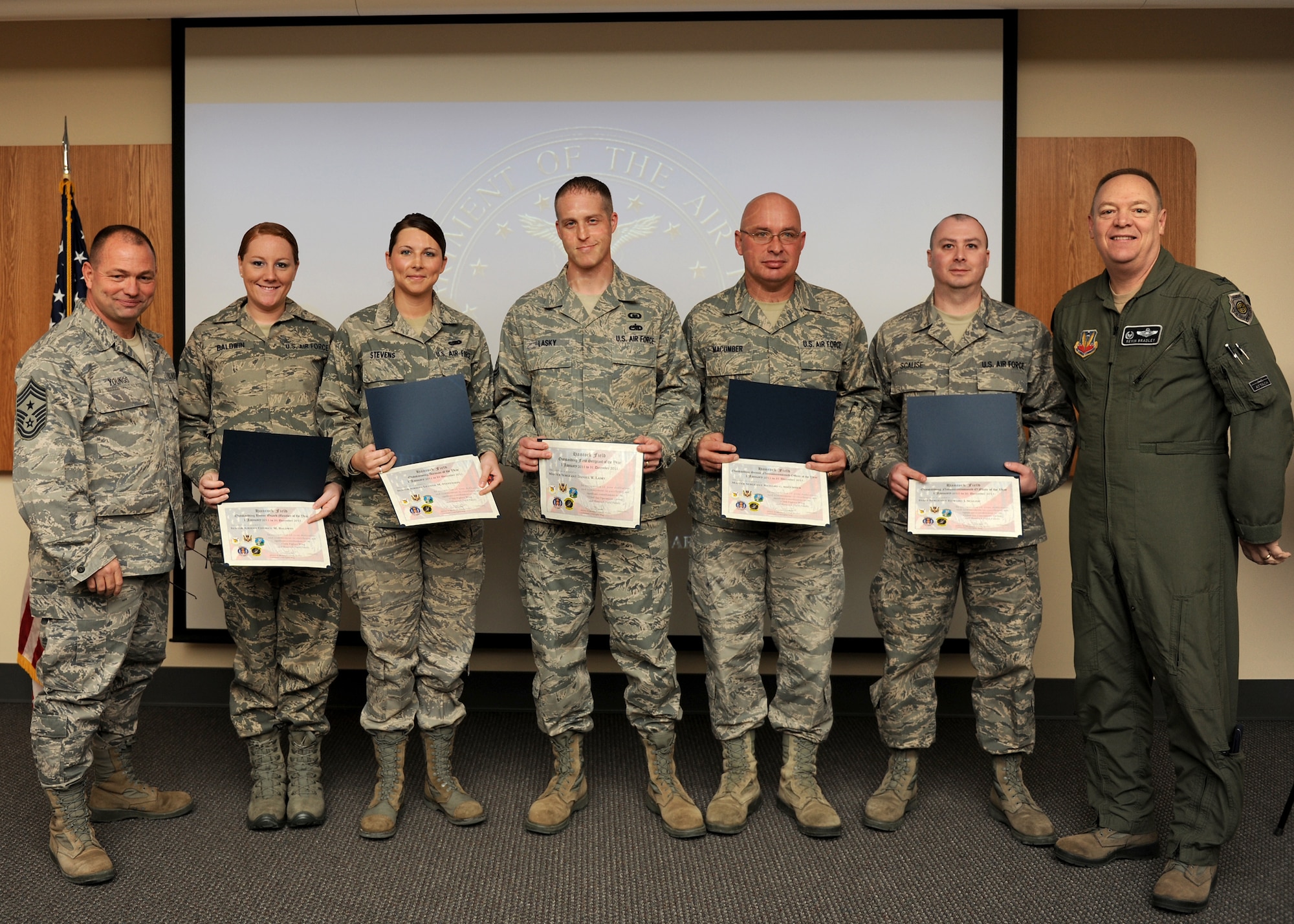 New York Air National Guard Col. Kevin Bradley (right), 174th Fighter Wing Commander, and Chief Master Sgt. Russell Youngs (left), 174th FW Command Chief, present Airmen of the Year awards to Hancock Field ANG Base personnel (from left to right) Senior Airman Cherice Baldwin, Senior Airman LeAnne Stevens, Master Sgt. Daniel Lasky, Master Sgt. Richard Macumber, and Staff Sgt. Edward Scalise on 7 January 2012.  The awards represented outstanding performance at the levels of Airman, NCO, Senior NCO, First Sergeant, and Honor Guard categories. (U.S. Air Force photo by Tech Sgt. Ricky Best/RELEASED)
