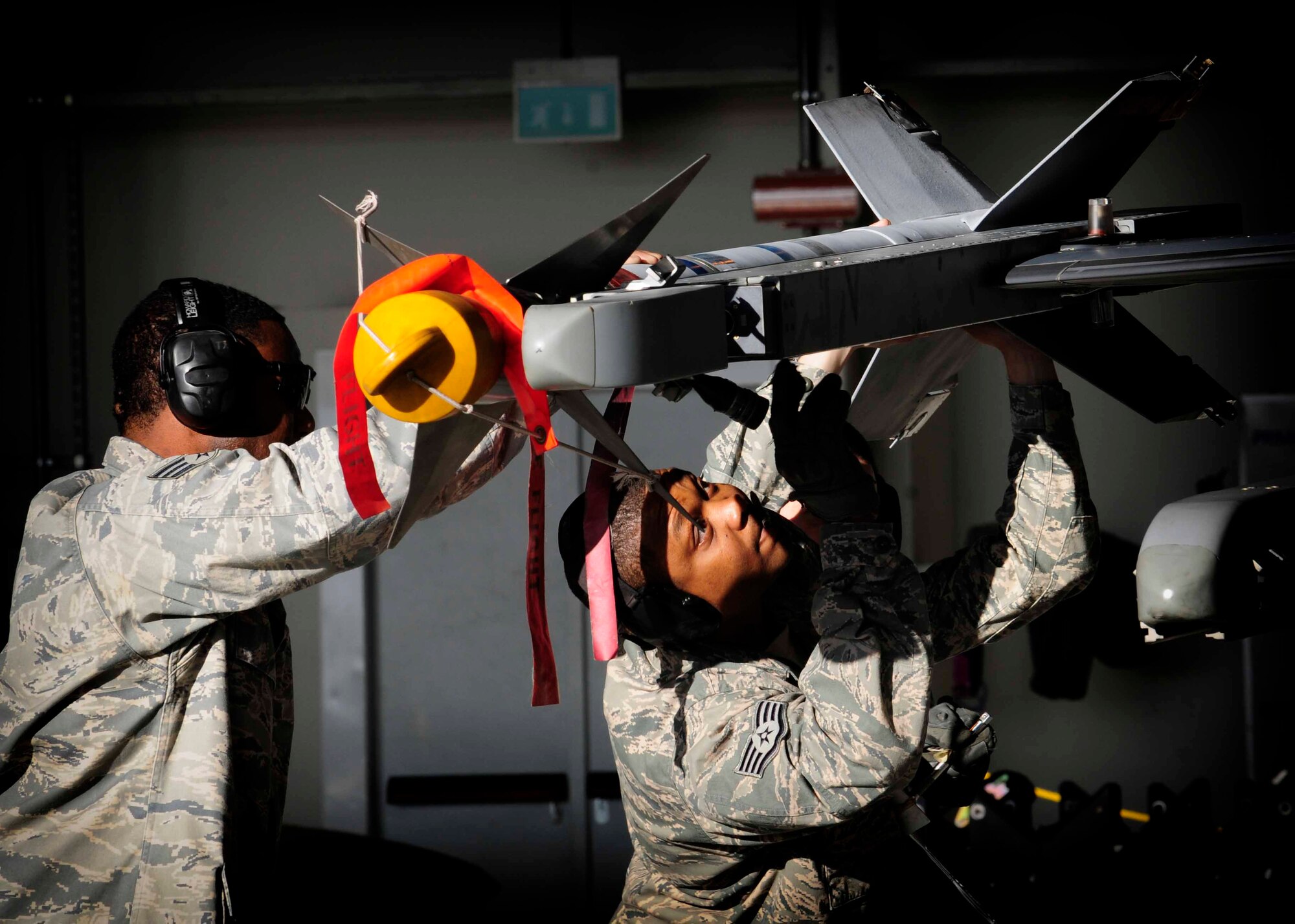 Senior Airman Julius Thomas, 31st Maintenance Group weapons load crew member, and Staff Sgt.Terelle Sayles, 31st Air Maintenance Squadron weapons load crew chief, secure munitions on an F-16 Fighting Falcon Jan.6 at Aviano Air Base, Italy. Airmen participated in the fourth quarter loading competition, which helps hone and practice their loading skills.(U.S. Air Force photo/Airman 1st Class Briana Jones)
 
