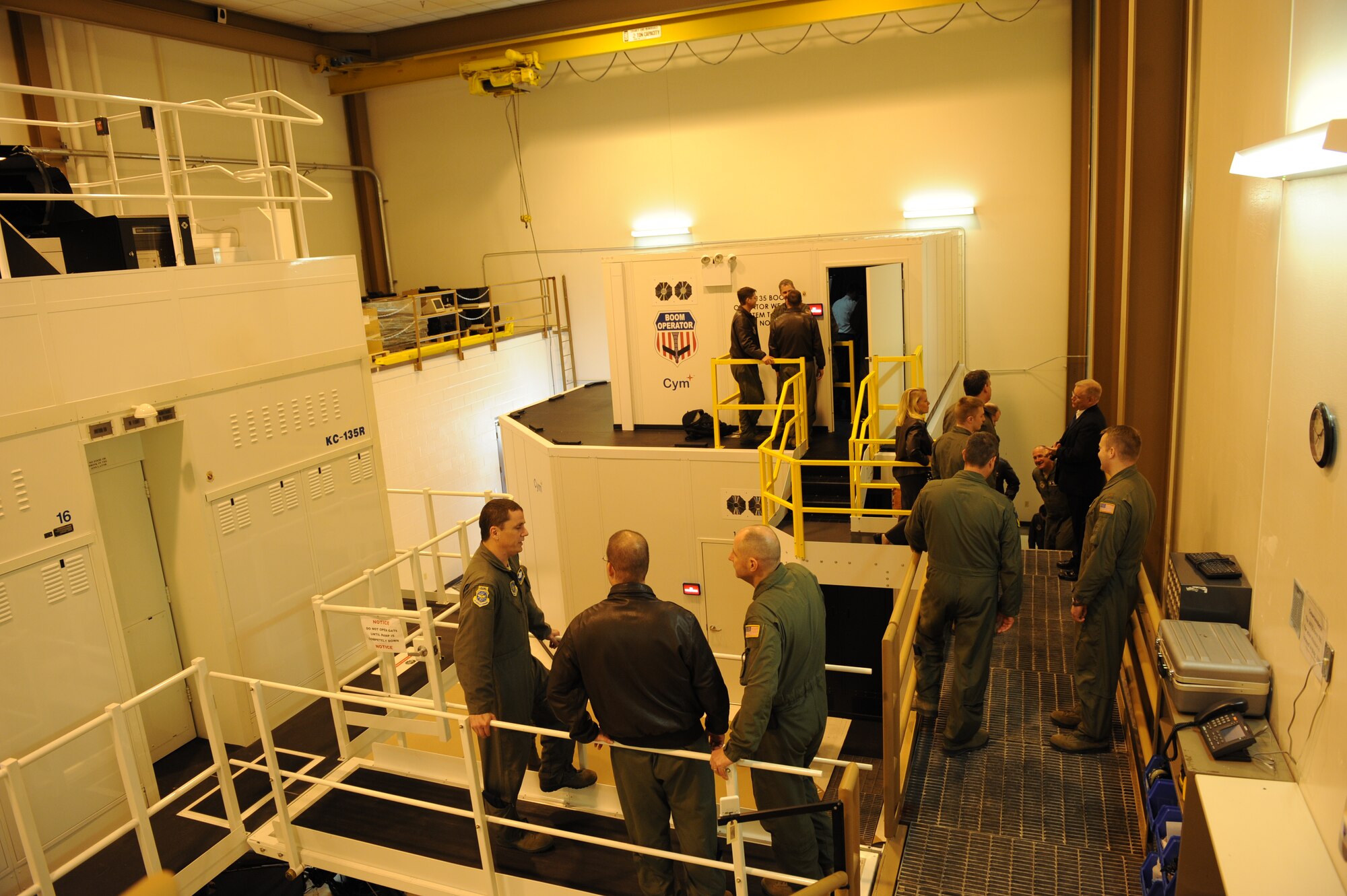 Air Mobility Command boom operators and pilots celebrate the opening of the Boom Operator Weapon System Trainer Jan. 9, 2012, McConnell Air Force Base, Kan. The BOWST is one way the Air Force is saving money and training while in a safe environment. (U.S. Air Force photo/ Airman 1st Class Maurice Hodges)