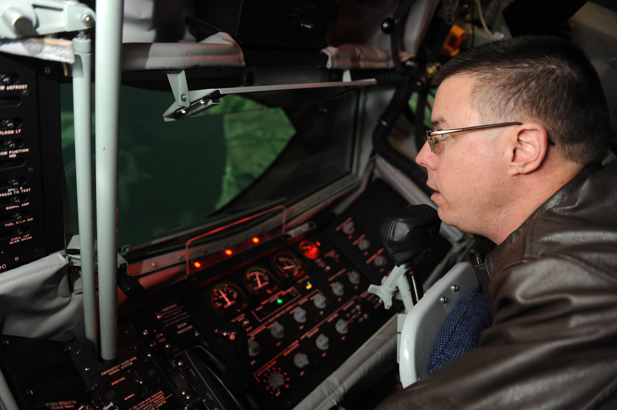 Tech. Sgt. Warren Weldon, 344th Air Refueling Squadron boom operator instructor, performs an air refueling procedure in the Boom Operator Weapon System Trainer Jan. 9, 2012, McConnell Air Force Base, Kan.  The BOWST is used to train boom operators for real-world operations while saving money and flying hours.  (U.S. Air Force photo/ Airman 1st Class Maurice Hodges)