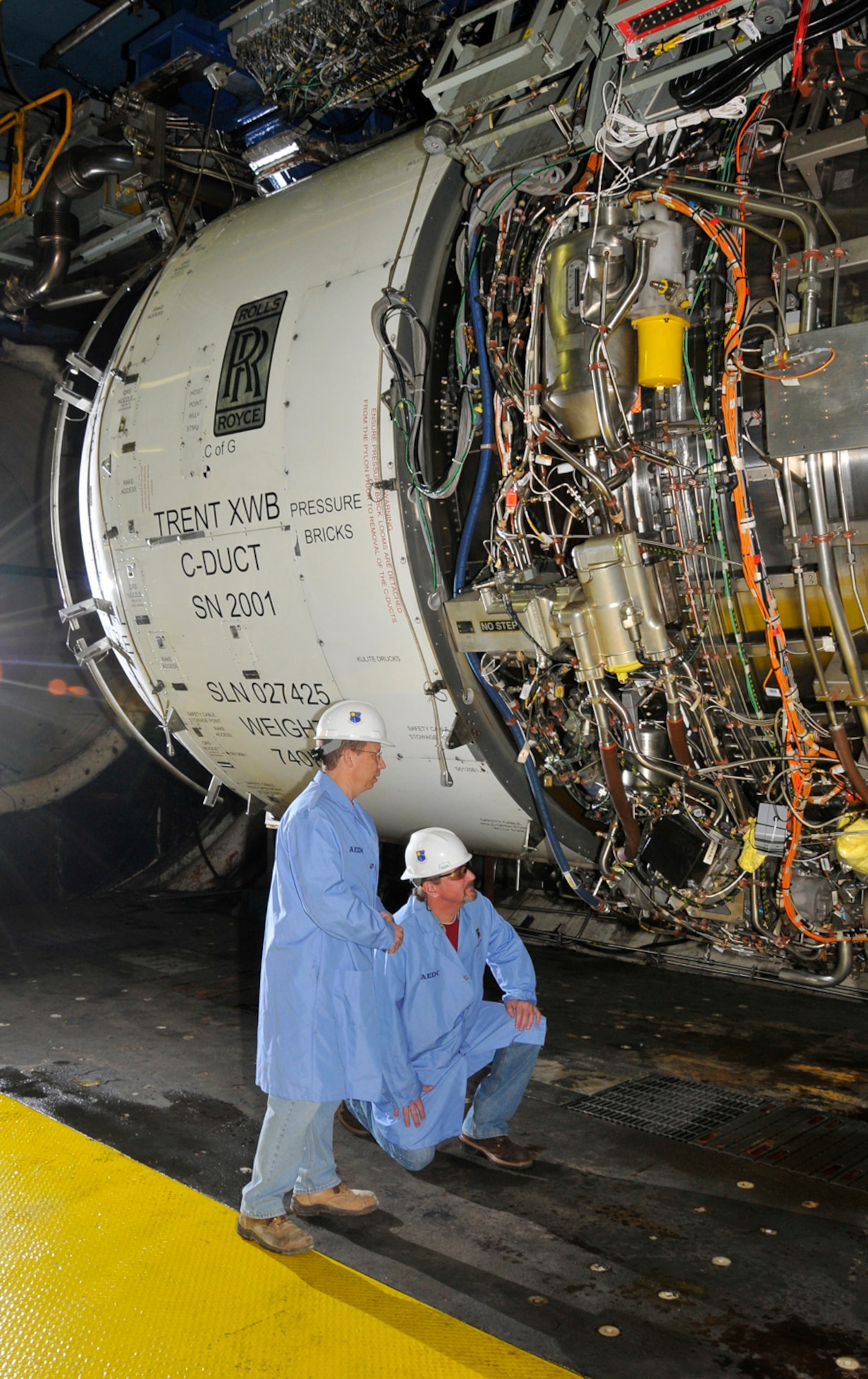 From left, Aerospace Testing Alliance outside machinists Danny Haddon and Garry Sudberry inspect the Rolls-Royce Trent XWB engine between simulated altitude performance and operability test runs in AEDC’s C2 test cell. The engine is the largest power plant ever tested at AEDC. (Photo by Rick Goodfriend) 