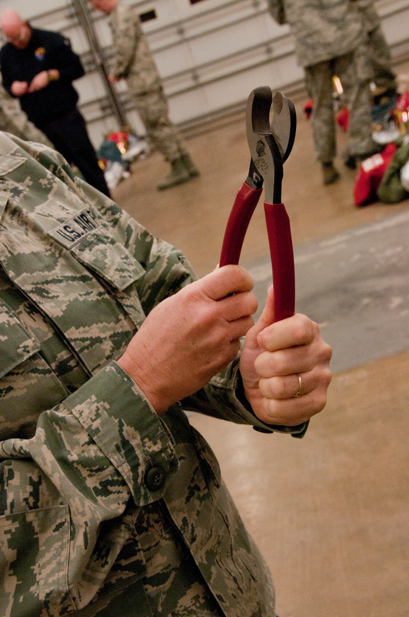 A member of the 162nd Fighter Wing fire station examines a new set of fire ground survival cutters donated by the Greater Tucson Fire Foundation. (U.S. Air Force photo/Tech. Sgt. Hollie Hansen)