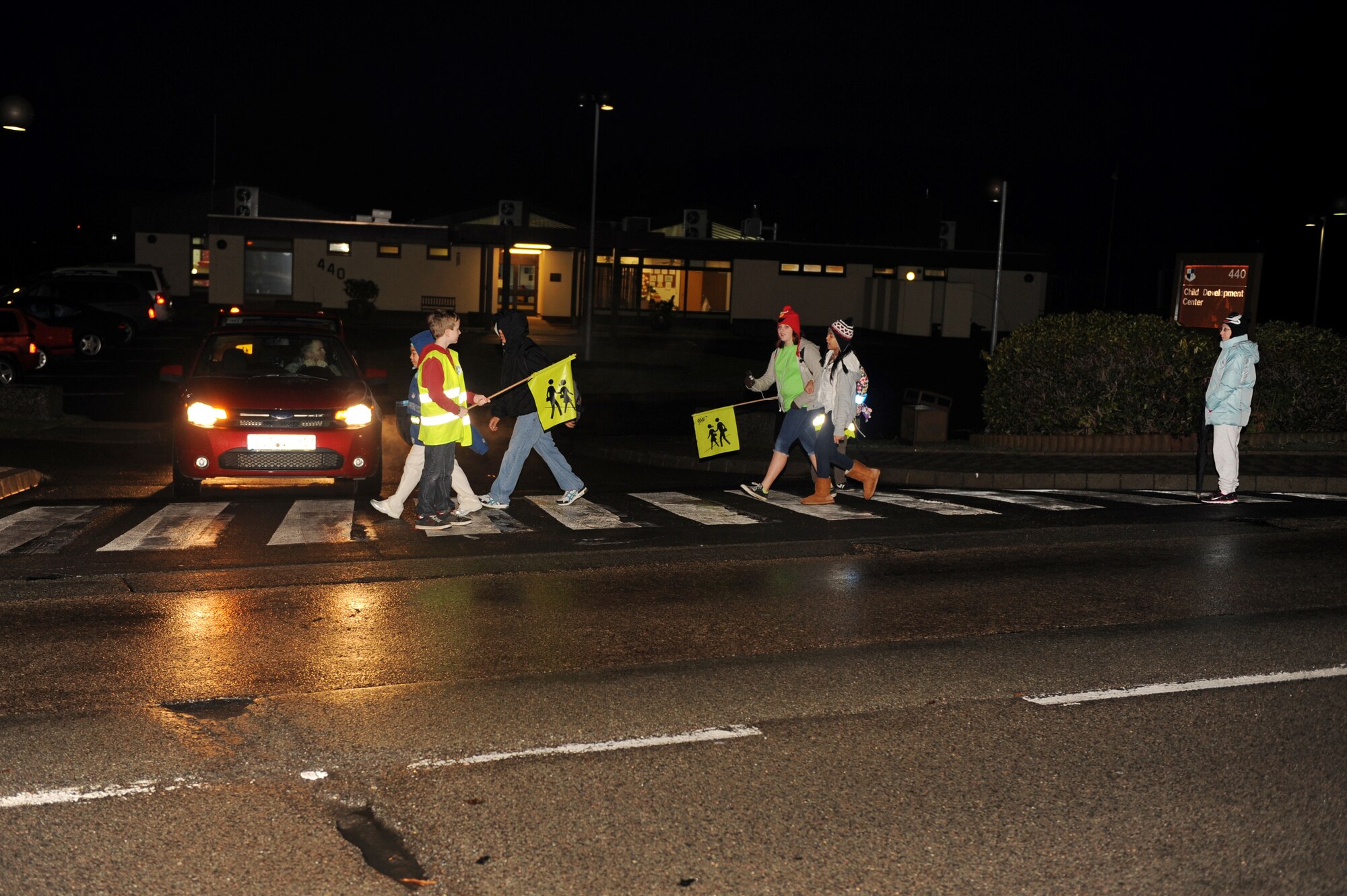 SPANGDAHLEM AIR BASE, Germany – Jonathan Varnadoe, left, Spangdahlem Middle School student, acts as a crossing-guard for his fellow students before school begins here Jan. 10. The 52nd Mission Support Group has designated the end of the bus lane in front of the school or the parking lot next to Bldg. 305 as drop-off points for the parents taking their children to school. The single crosswalk to cross Arnold Boulevard is located across from the Child Development Center. The middle school also has crossing guards posted there. The school zone now has a full-time 30 kph speed limit. (U.S. Air Force photo/Airman 1st Class Matthew B. Fredericks)