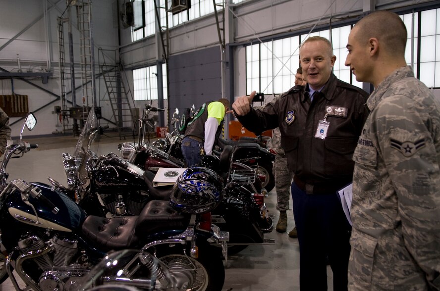 Col. Daniel Dant, Installation Excellence Selection Board team member, speaks with an Airman about motorcycles on Barksdale Air Force Base, La., Jan. 9. A motorcycle safety and mentorship group, the Green Knights, were present to speak with Dant and other members of the IES board about motorcycle safety programs. (U.S. Air Force photo/Airman 1st Class Benjamin Gonsier)(RELEASED)