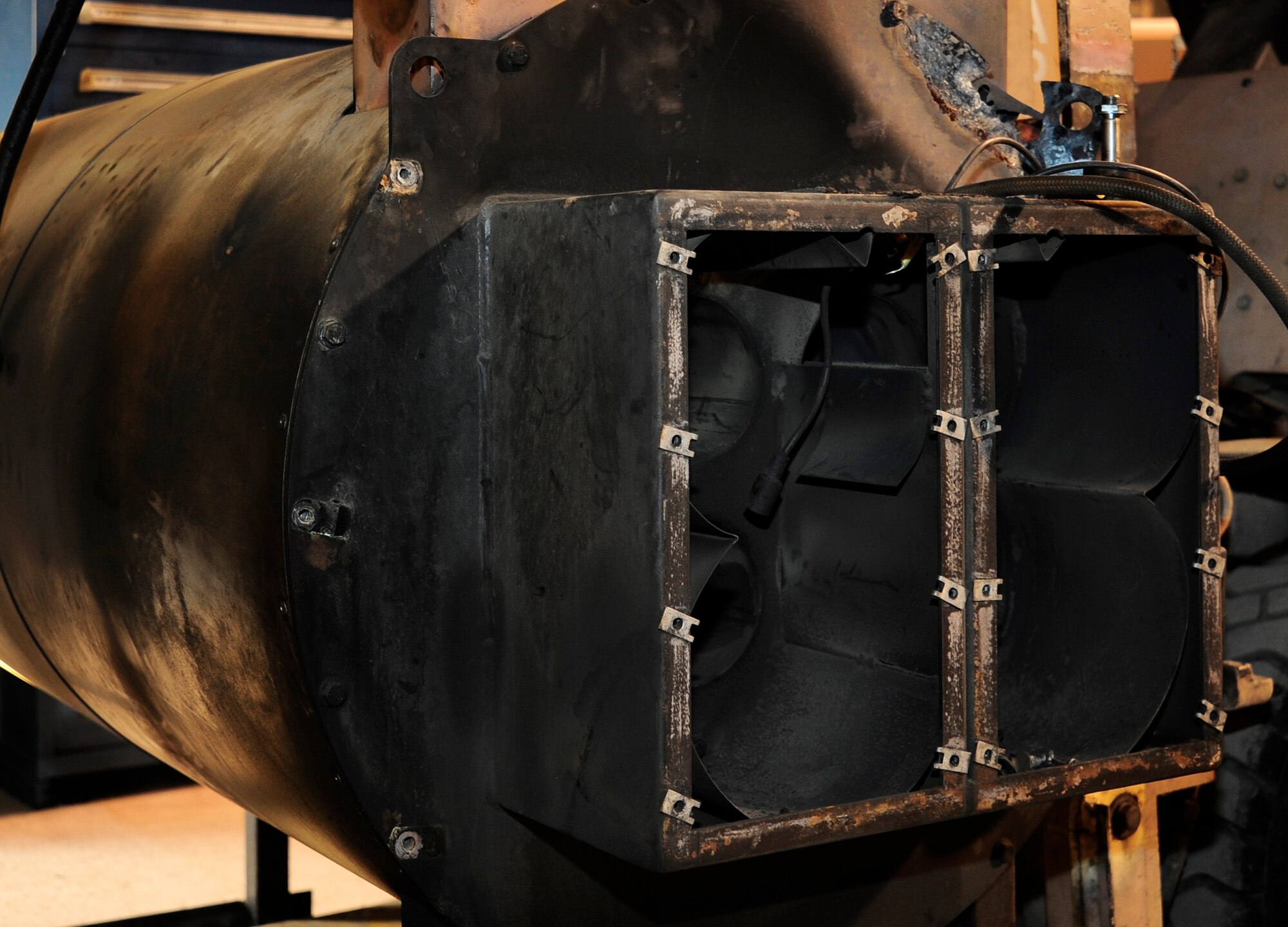 A burnt broiler unit that was replaced from a standard deicer truck is displayed Jan. 6, 2012, in the vehicle maintenance special purpose shop at the Transit Center at Manas, Kyrgyzstan. Seven Airmen from the 376th Expeditionary Logistics Readiness Squadron replaced a standard deicer truck’s heater canister and supporting hardware in seven hours. (U.S. Air Force Photo/Staff Sgt. Angela Ruiz)
