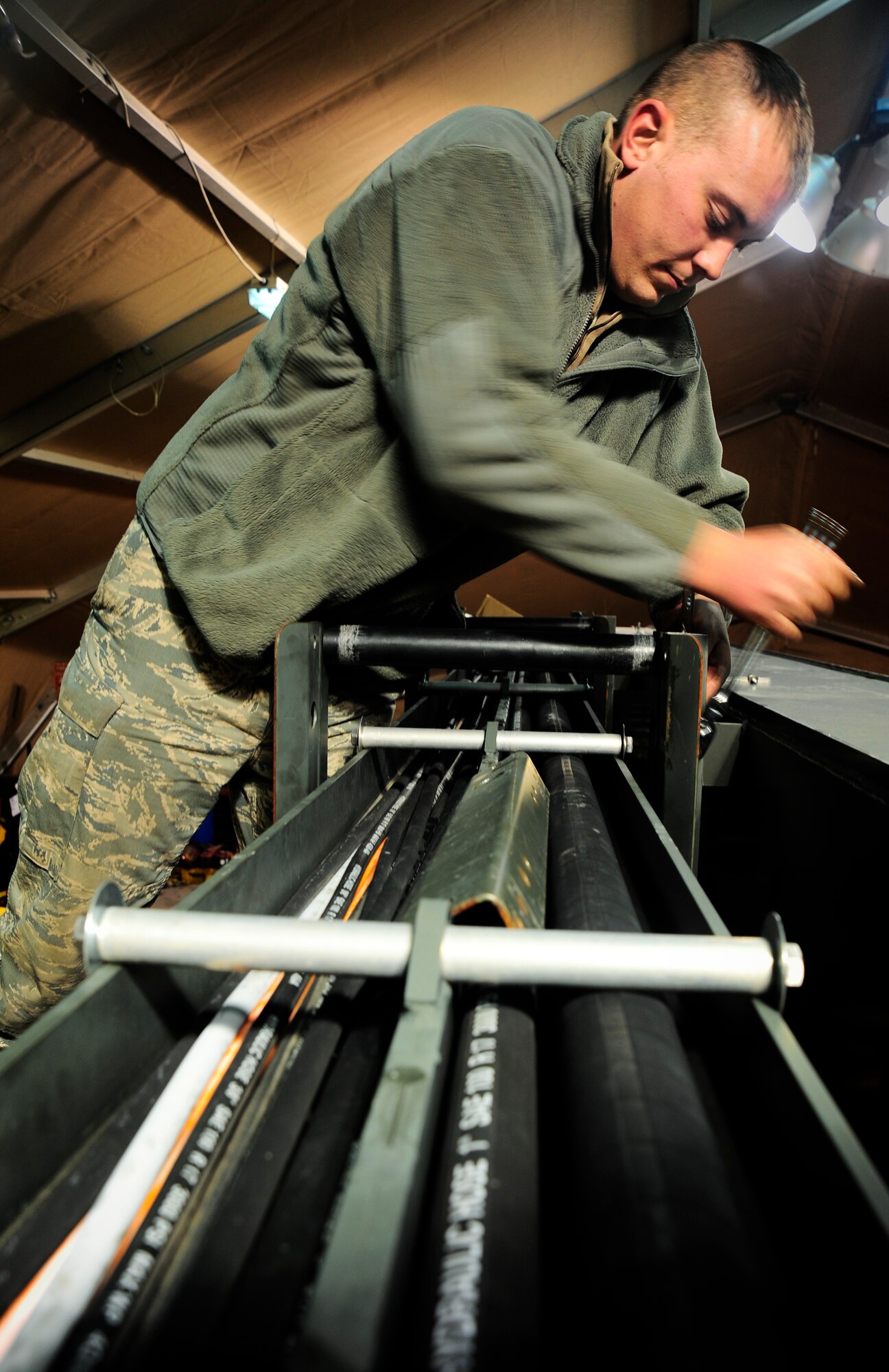Staff Sgt. Anthony Tanner installs cat track guides into an extended reach deicer truck Jan. 6, 2012, in the vehicle maintenance special purpose shop at the Transit Center at Manas, Kyrgyzstan. The extended reach deicer truck’s purpose is to remove ice from the wings of large aircraft, enabling them to fly. Tanner is a vehicle maintainer with the 376th Expeditionary Logistics Readiness Squadron deployed here from the 117th Air Refueling wing, Ala. (U.S. Air Force Photo/Staff Sgt. Angela Ruiz)