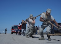 902d Mission Support Group, Fire department personnel compete in the Fire Truck pull event, 7 Jan, during the 2d Annual Battle of the Badges event held at Randolph Air Force Base. (U.S. Air Force photo/Joel Martinez)