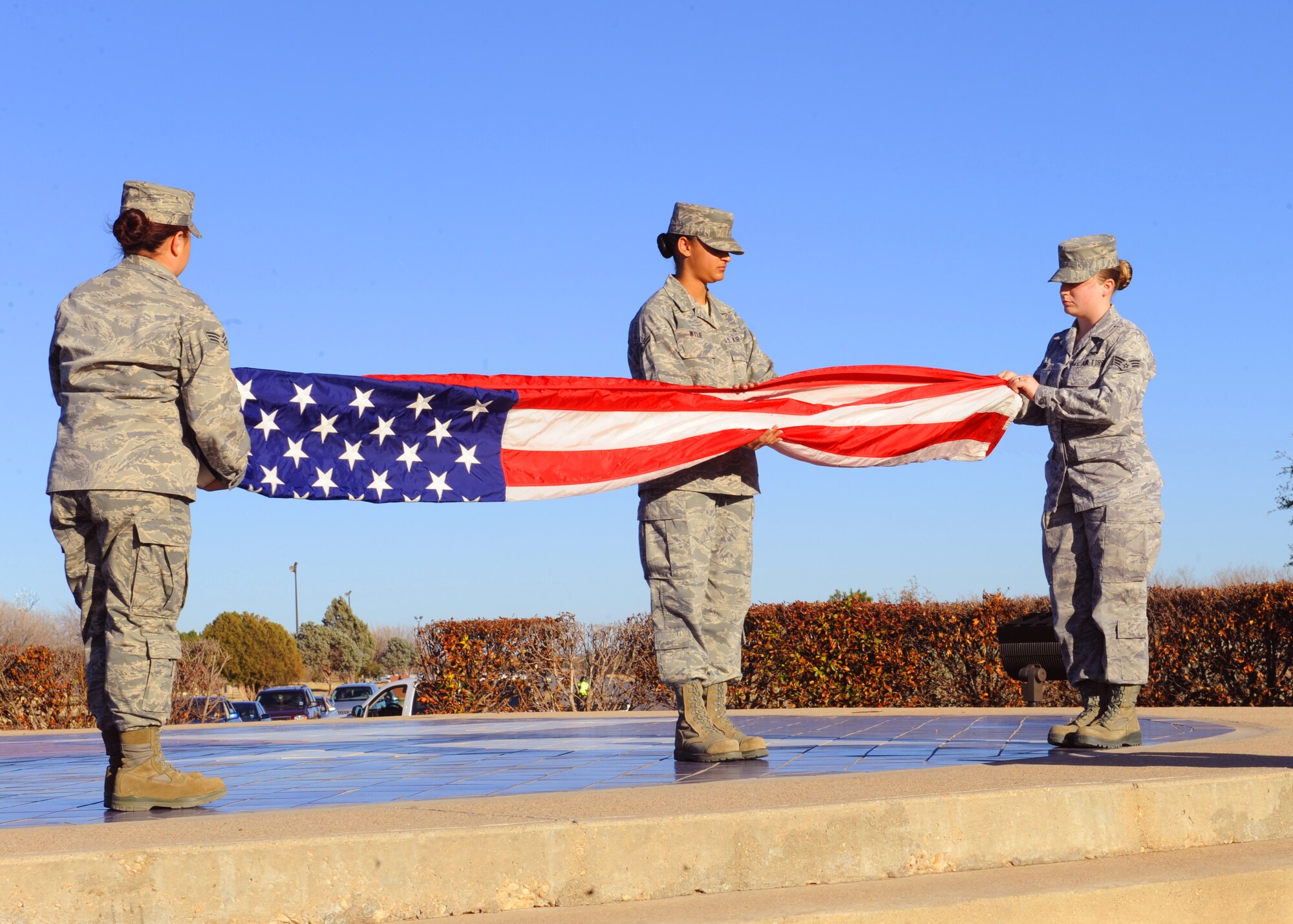 Dyess Honor Guardsmen fold the flag during a retreat ceremony, Jan. 6, 2012, at Dyess Air Force Base, Texas. A retreat ceremony signifies the end of a duty day and is also a way to pay tribute to the American flag. (U.S. Air Force photo by Airman 1st Class Cierra Bullock/Released) 