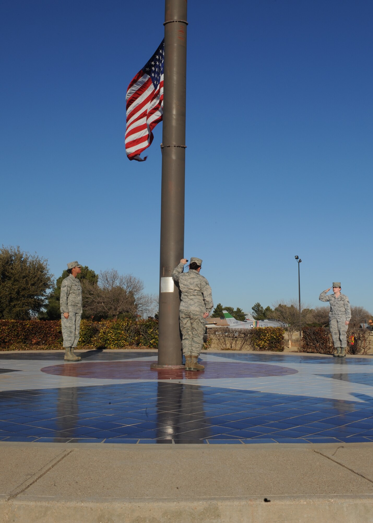 Dyess Honor Guardsmen lower the flag during a retreat ceremony, Jan. 6, 2012, at Dyess Air Force Base, Texas. A retreat ceremony signifies the end of a duty day and is also a way to pay tribute to the American flag. (U.S. Air Force photo by Airman 1st Class Cierra Bullock/Released)