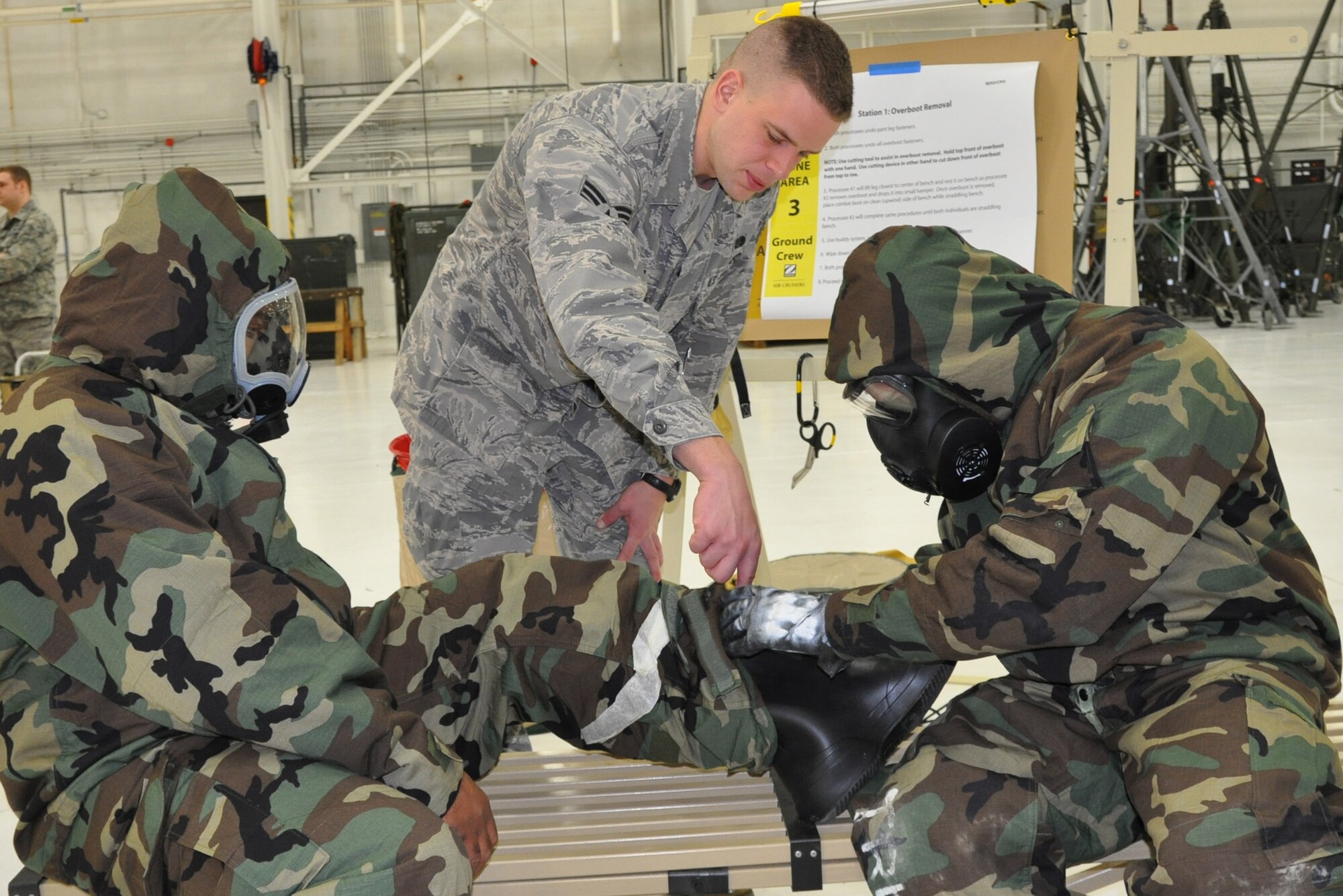 Air Force Reserve Senior Airman Nathan T. Kieffer, an Emergency Management Journeyman with the 910th Civil Engineer Squadron, trains airmen on how to remove chemical protective over boots during a training session here Jan. 8.    