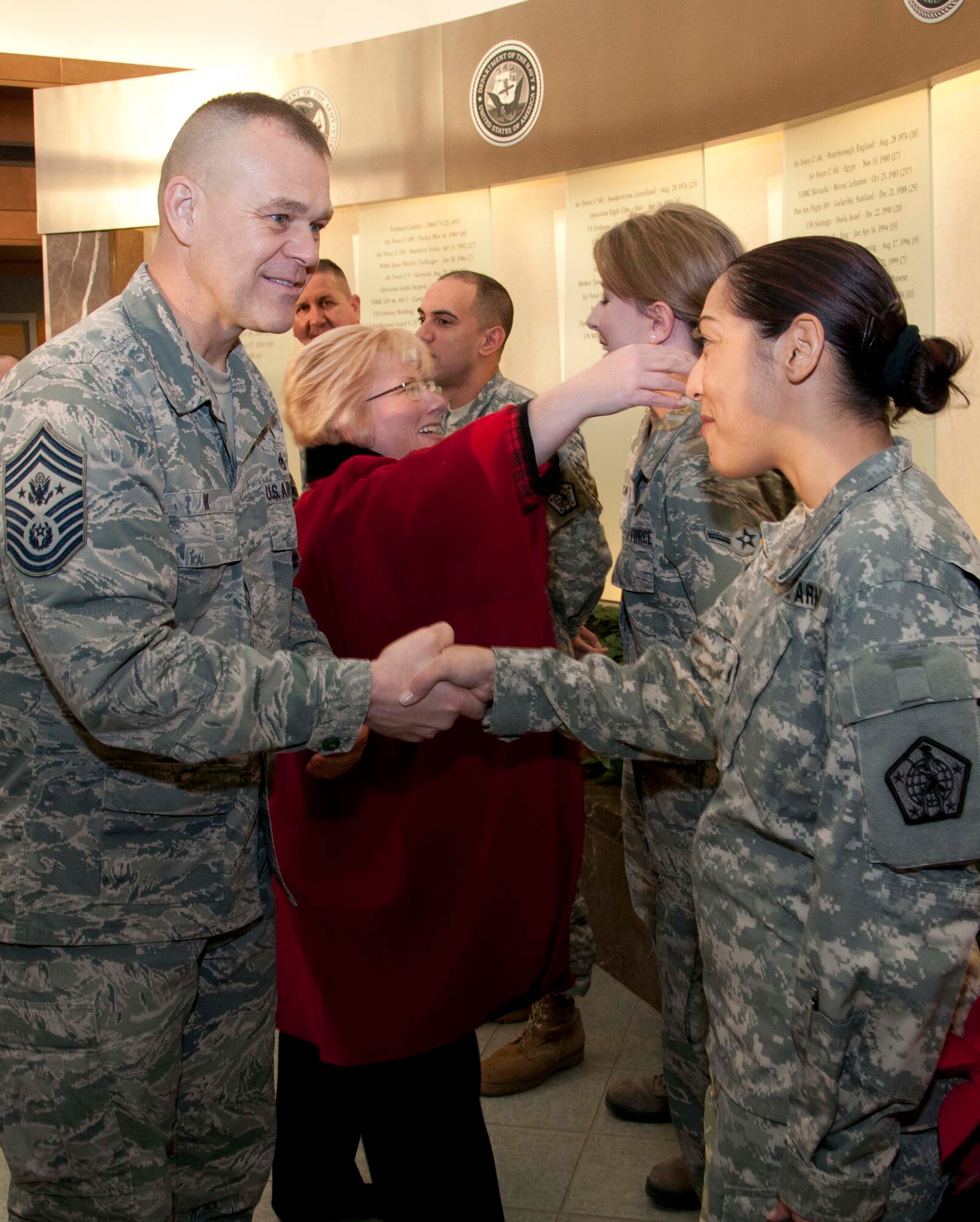 Chief Master Sgt. of the Air Force James A. Roy shakes hands with Army Sgt. Mariangelica Aviles Jan. 6, 2012 at the Charles C. Carson Center for Mortuary Affairs, Dover Air Force Base, Del.  Roy toured the mortuary facility, the Joint Personal Effects Depot and the campus for families of the fallen. (U.S. Air Force photo/Staff Sgt. Agustin Salazar)