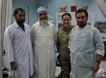 Maj. Courtney Schapira poses with, from left, dental technician Nasir, dental clinic chief Dost Muhammad and dentist Janat at Forward Operating Base Lightning. Schapira is currently on a six-month deployment in Afghanistan as the Chief Dental Advisor at Paktia Regional Military Hospital in Gardez and is from the 628th Medical Group at Joint Base Charleston, S.C. (U.S. Air Force Photo/Staff Sgt. Sarah Martinez)