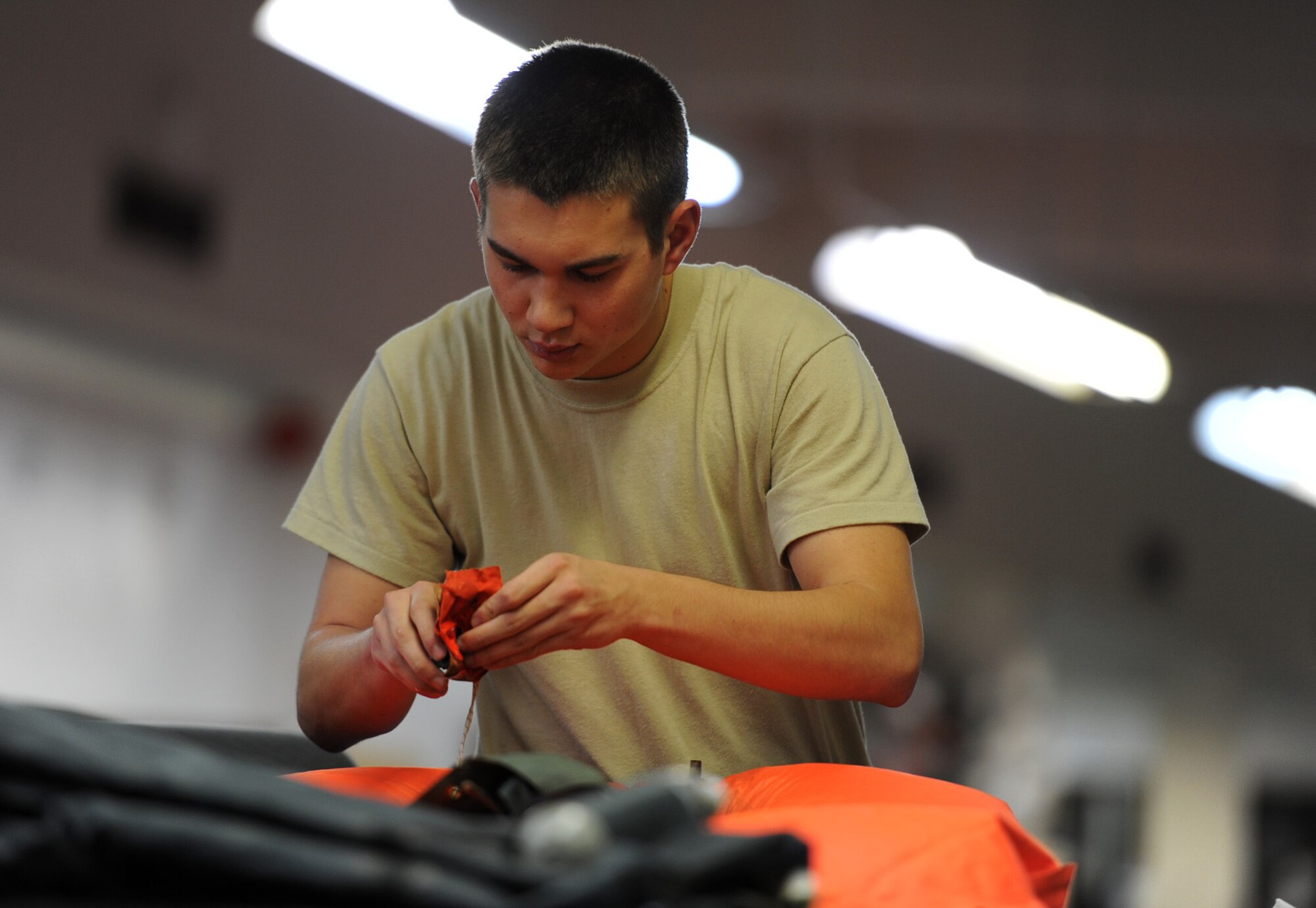 U.S. Air Force Airman 1st Class Corey Harrison, 18th Operations Support Squadron air crew flight equipment apprentice, repairs a life preserver unit during Beverly High 12-2, a local operational readiness exercise at Kadena Air Base, Japan, Jan 10, 2012. The 18th Wing is participating in the LORE Jan. 9-11 to test the readiness of Kadena Airmen. (U.S. Air Force photo by Senior Airman Jarvie Z. Wallace)

