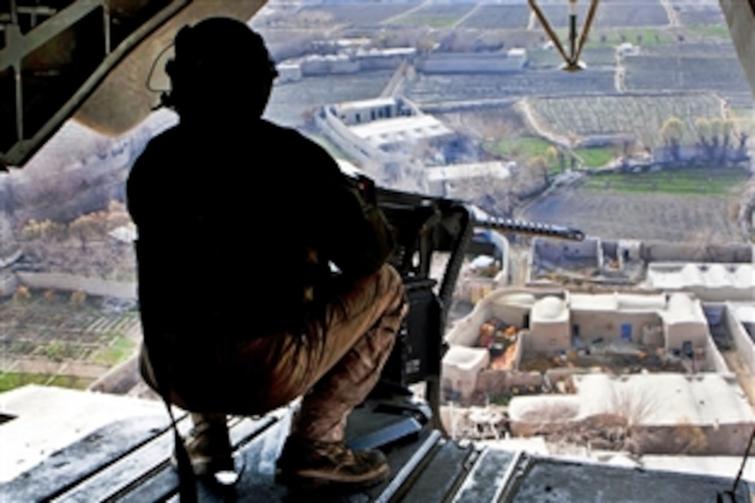 U.S. Marine Corps Lance Cpl. Madison DeLoach observes the terrain during a routine flight operation in Helmand province, Afghanistan, Jan. 5, 2012. DeLoach is a crew chief assigned to Marine Heavy Helicopter Squadron 363. 