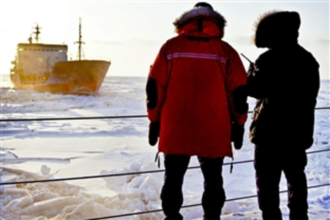 Crew members aboard the U.S. Coast Guard Cutter Healy observe the Russian-flagged tanker Renda as it follows the Healy's trail through the ice in the Bering Sea, Jan. 8, 2012. The 420-foot, Seattle-based cutter was escorting and assisting Renda on its mission to deliver more than 1.3 million gallons of fuel to Nome, Alaska.