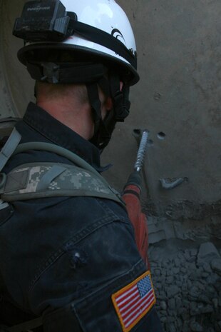 A soldier from 911th U.S. Army Technical Rescue Engineer Company drills more holes in a concrete barrier in order to make it easier to breach the wall in order for his team to move further through the simulated collapsed structure in their search for "victims" who were trapped in the collapse during the joint 72-hour technical rescue training operation with the 911th U.S. Army Technical Rescue Engineer Company at Downey Responder Training Facility. The two units take the opportunity to train together to build a good working relationship and familiarity of each other’s capabilities and limitations. Since both units cover the National Capitol Region, in the event of a disaster both units would work side by side.