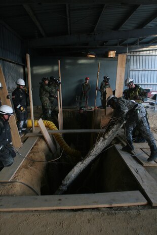 Soldiers from 911th U.S. Army Technical Rescue Engineer Company and Marines from Chemical Biological Incident Response Force's Technical Rescue Platoon work to stabilize a trench before attempting to enter and extract two “victims” after a simulated collapse during CBIRF's annual 72-hour technical rescue training operation at the Downey Responder Training Facility. This joint 72-hour technical rescue training operation at DRTF allowed the two units take the opportunity to train together to build a good working relationship and familiarity of each other’s capabilities and limitations. Since both units cover the National Capitol Region, in the event of a disaster, both units would work side by side.