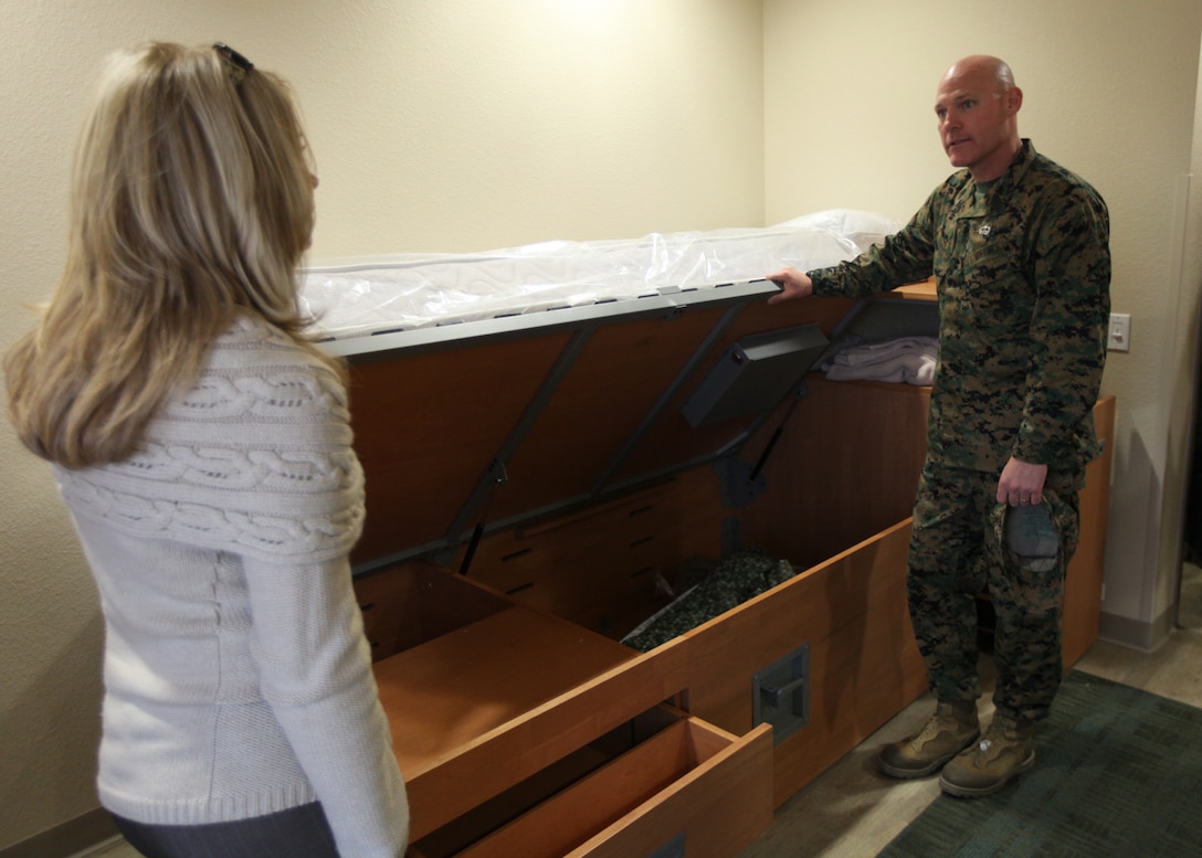 Monique Ramirez, the director of billeting of bachelor housing, gives Sergeant Major of the Marine Corps Micheal P. Barrett a tour of the living quarters at the bachelor enlisted quarters bedrooms at Camp Pendleton, Calif., Jan. 11.