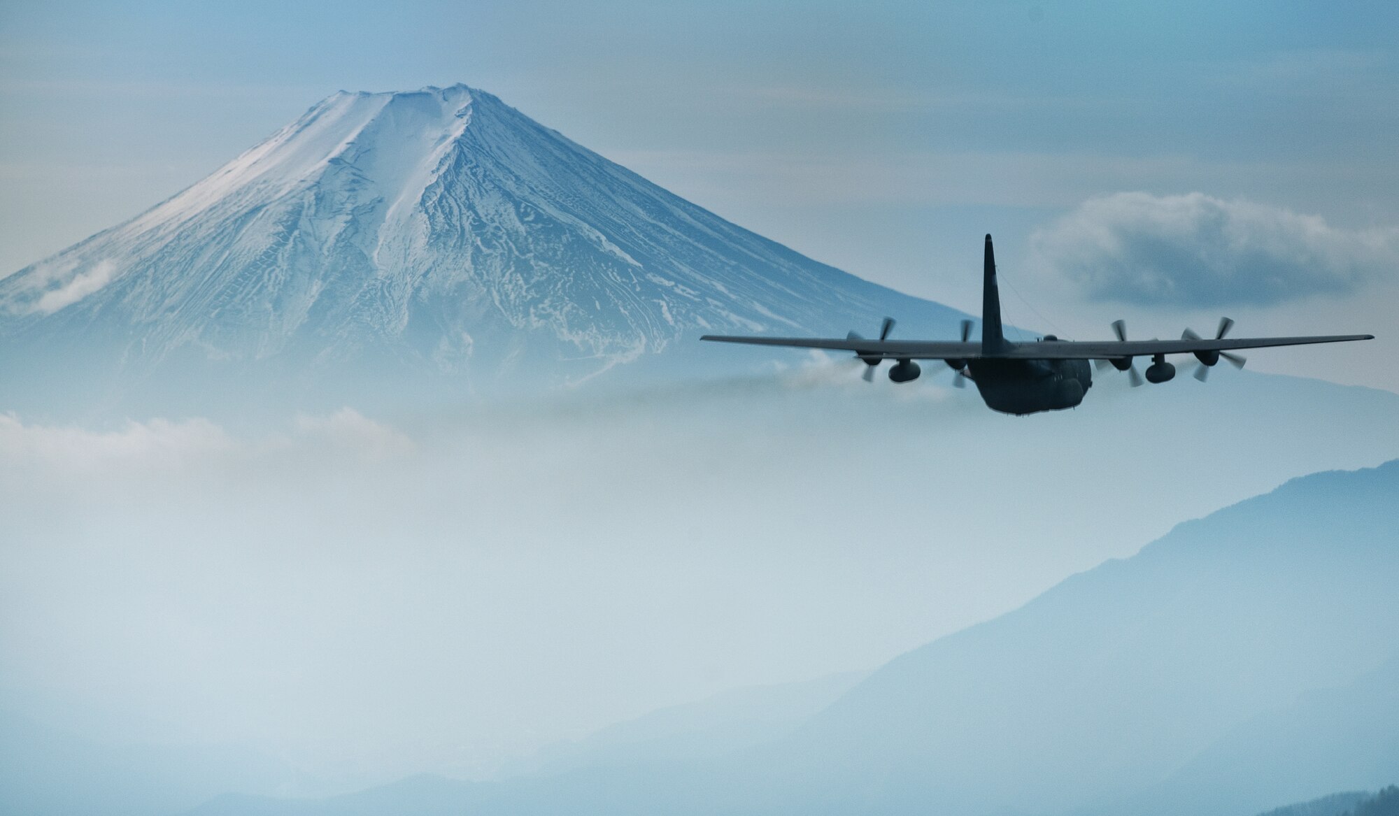 OVER JAPAN-- A C-130 Hercules aircraft flies towards Mount Fuji during an airdrop training mission, Jan. 10, 2012. (U.S. Air Force photo/Osakabe Yasuo)