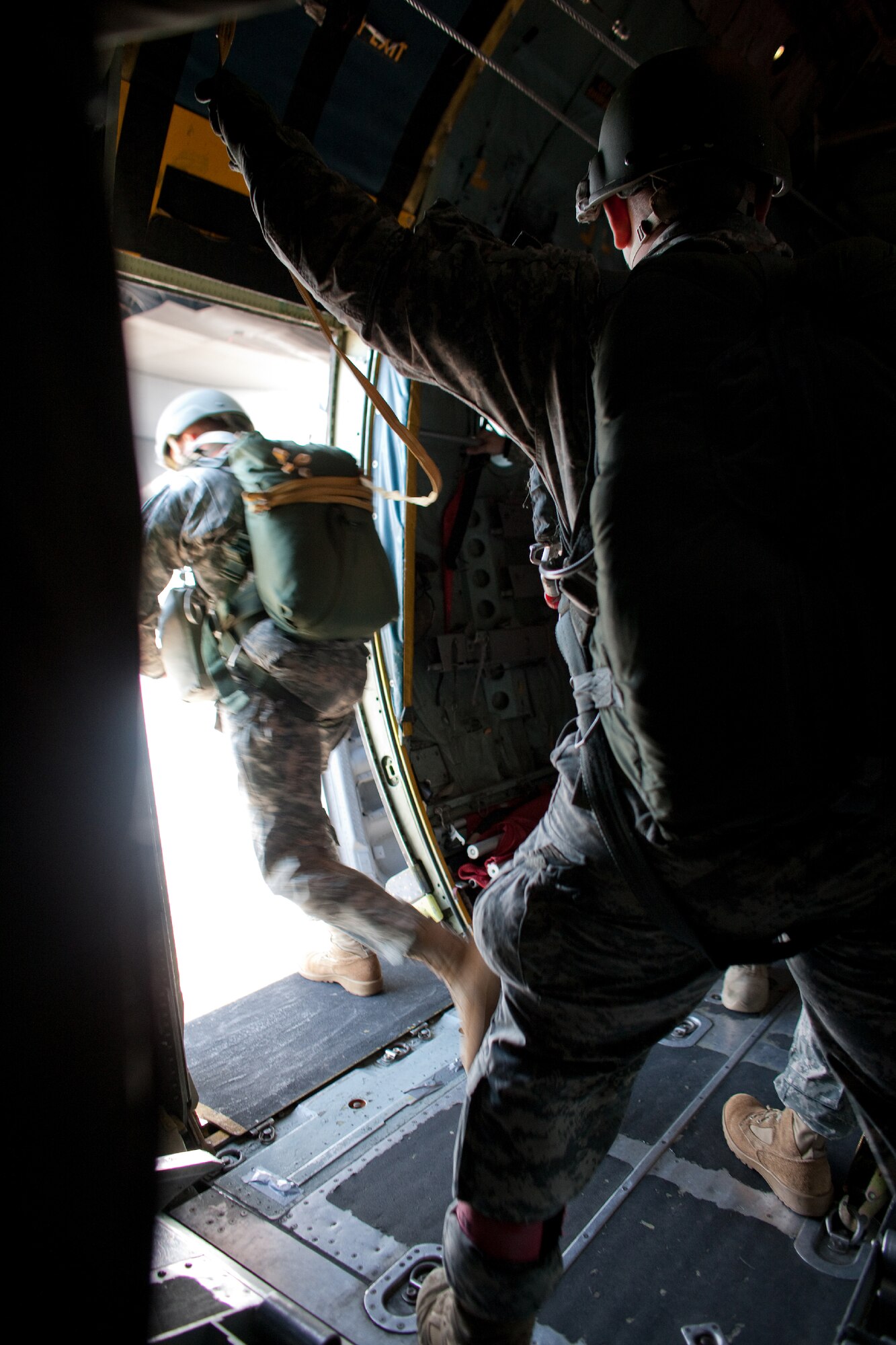 OVER YOKOTA AIR BASE, Japan -- A U.S. Army soldier, assigned to units in the Pacific Theater, parachutes from a C-130 Hercules, from more than 1,000 feet above Yokota Air Base, Japan, Jan. 10, 2012. Over 100 soldiers and Yokota Airmen conducted routine airdrop training during an airfield surge exercise. (U.S. Air Force photo/Osakabe Yasuo) 
