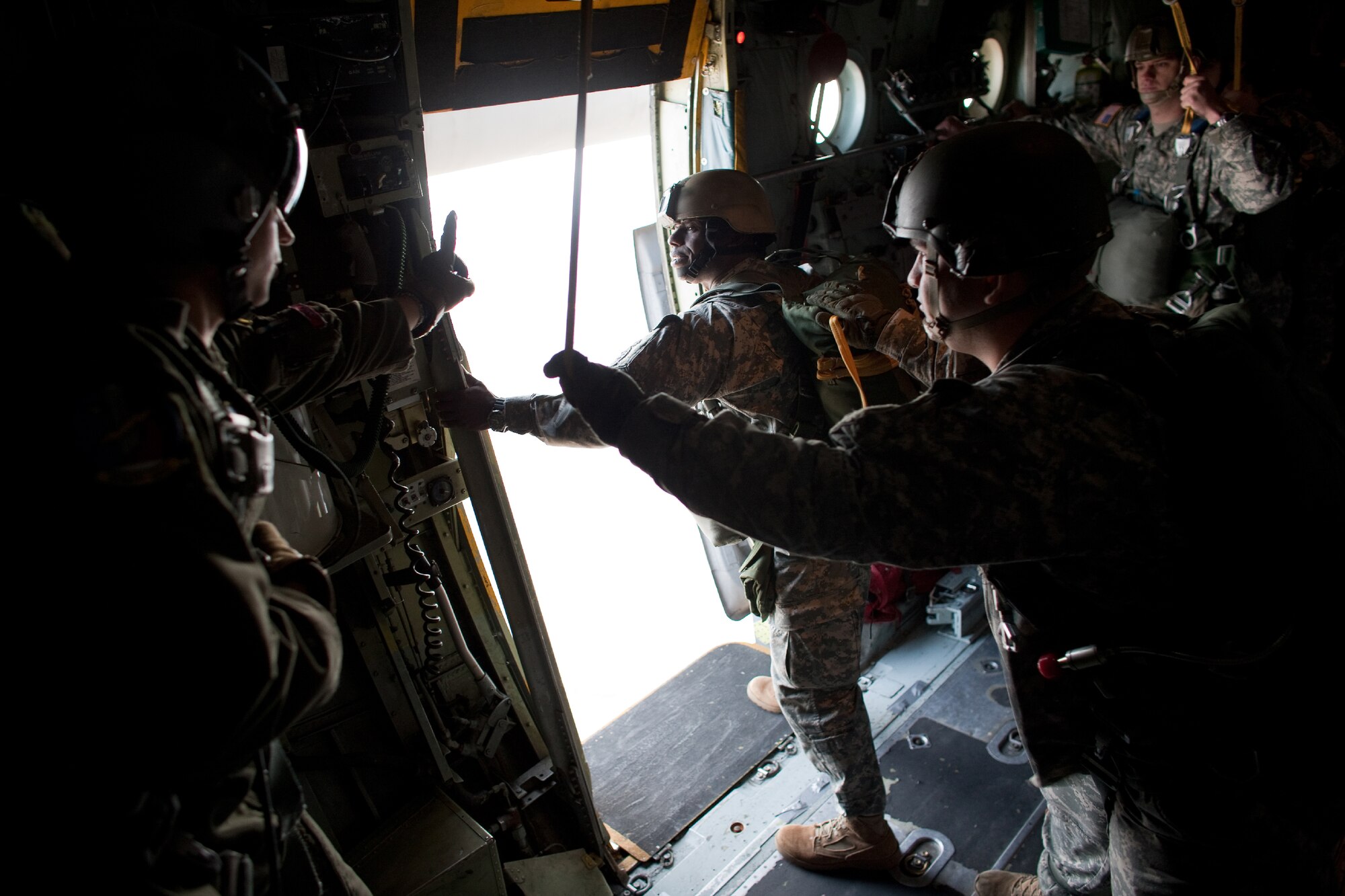 OVER YOKOTA AIR BASE, Japan -- A U.S. Army soldier, assigned to a unit in the Pacific Theater, is ready for jumping in a C-130 Hercules, from more than 1,000 feet above Yokota Air Base, Japan, Jan. 10, 2012. Over 100 soldiers and Yokota Airmen conducted routine airdrop training during an airfield surge exercise. (U.S. Air Force photo/Osakabe Yasuo) 