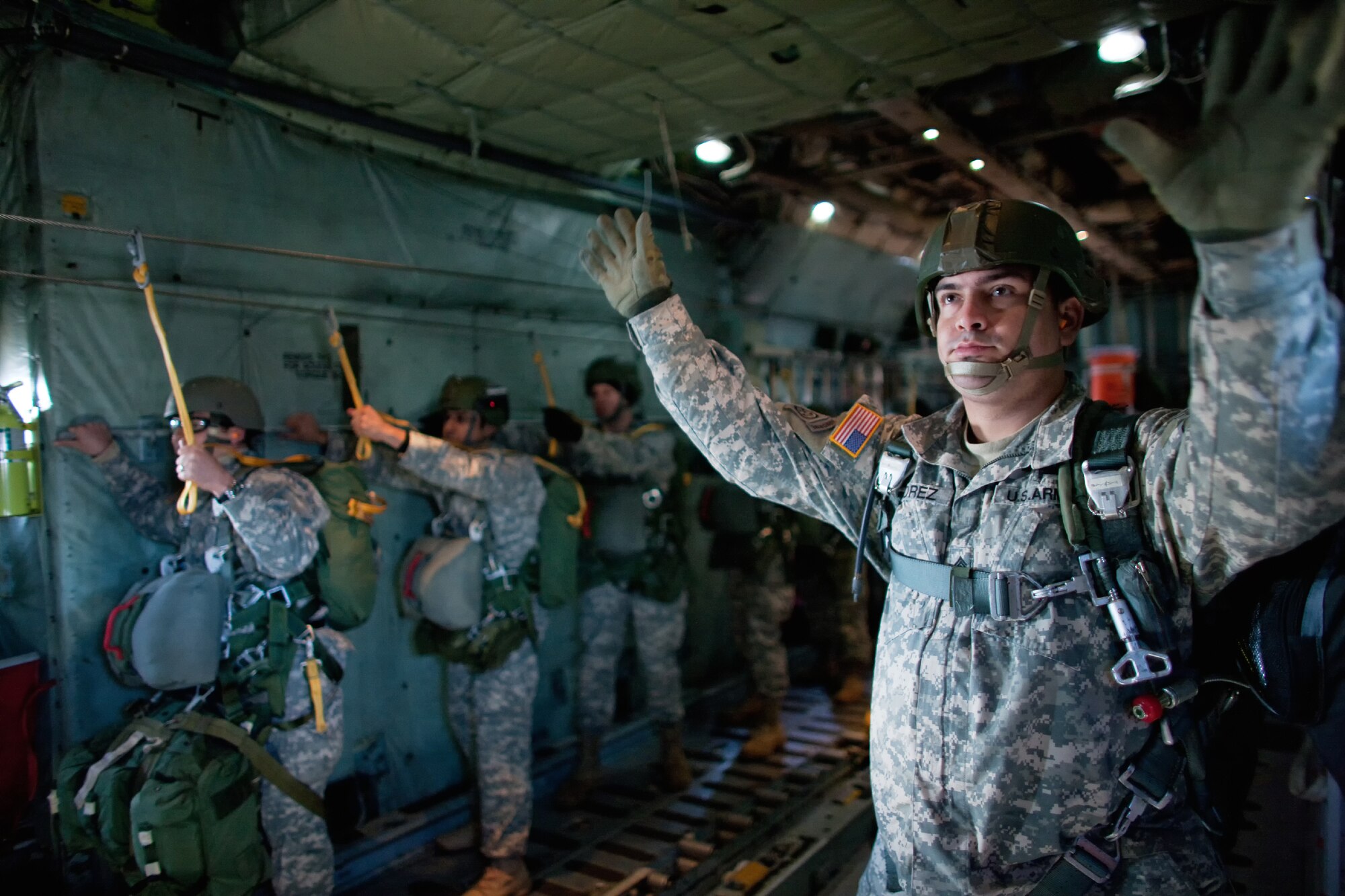 OVER YOKOTA AIR BASE, Japan -- A U.S. Army soldier assigned to a unit in the Pacific Theater communicates with the loadmaster using hand signals to countdown a jump above Yokota Air Base, Japan, Jan. 10, 2012. Over 100 soldiers and Yokota Airmen conducted routine airdrop training during an airfield surge exercise. (U.S. Air Force photo/Osakabe Yasuo)