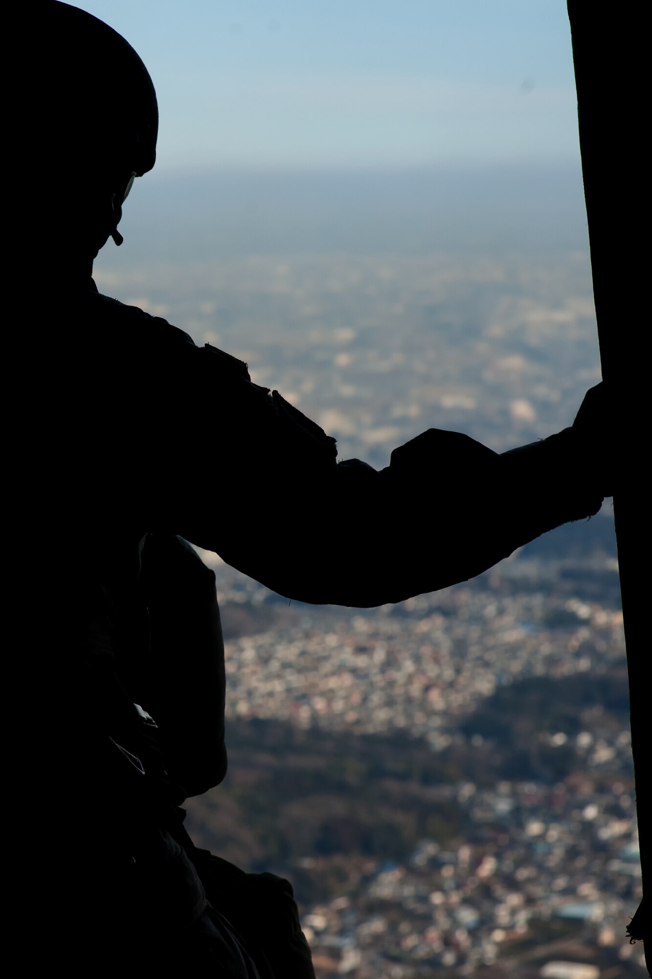 OVER YOKOTA AIR BASE, Japan -- A U.S. Army soldier assigned to units in the Pacific Theater waits to jump in a C-130 Hercules, from more than 1,000 feet above Yokota Air Base, Japan, Jan. 10, 2012. Over 100 soldiers and Yokota Airmen conducted routine airdrop training during an airfield surge exercise. (U.S. Air Force photo/Osakabe Yasuo)
