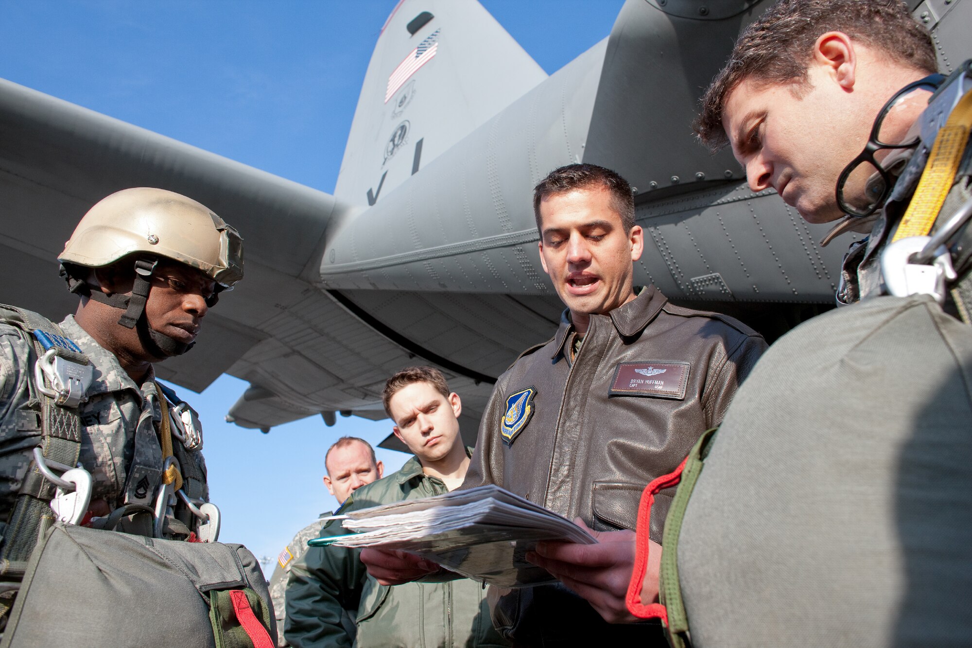 YOKOTA AIR BASE, Japan -- Capt. Bryan Huffman (center), 36th Airlift Squadron navigator, gives a flight plan briefing to paratroopers from U.S. Army units in the Pacific Theater, by a C-130 Hercules at Yokota Air Base, Japan, Jan. 10, 2012. Over 100 soldiers and Yokota Airmen conducted routine airdrop training during an airfield surge exercise. (U.S. Air Force photo/Osakabe Yasuo)   
