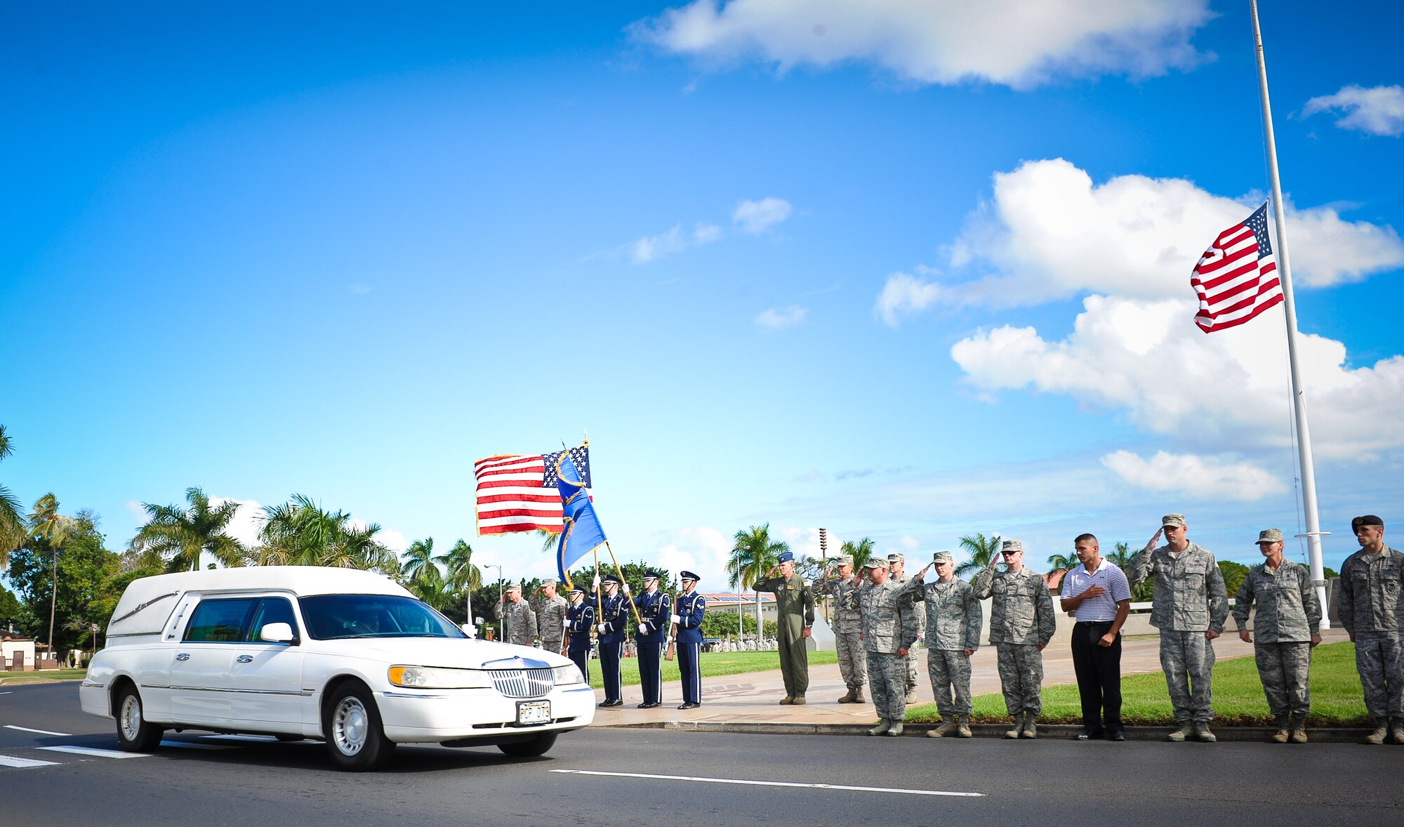 Airmen line Atterbury Circle on Joint Base Pearl Harbor-Hickam to salute and pay their respects as the remains of Wilfred "Fred" Toczko, a retired Army captain and Hickam Field Survivor, pass by, Jan. 11. Toczko began his military career as a young enlisted Soldier who displayed noteworthy heroism Dec. 7, 1941. (U.S. Air Force photo/Senior Airman Lauren Main)
