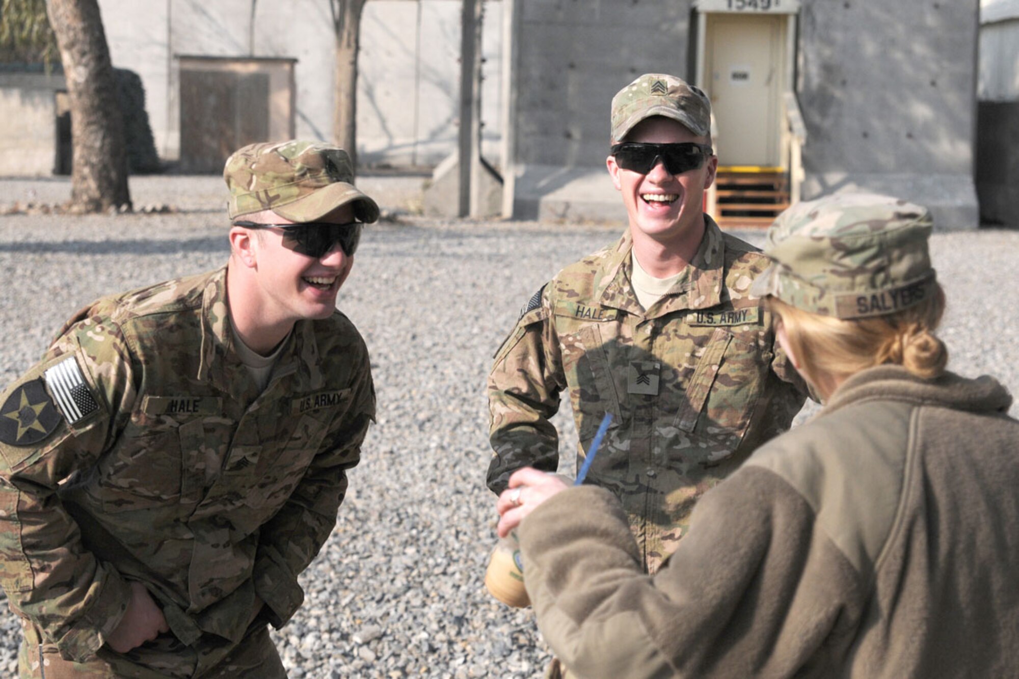 Sgt. Adam M. Hale, an infantryman with the 2nd Battalion, 28th Infantry Regiment, 172nd Infantry Brigade (left), U.S. Army Sgt. Nicholaus A. Hale, a squad leader with the 1st Battalion, 24th Infantry Regiment, 1st Stryker Brigade Combat Team, 25th Infantry Division and U.S. Army Capt. Rikki Salyers of the Indiana National Guard’s 4-19th Agribusiness Development Team share a laugh after being reunited on Forward Operating Base Salerno, Afghanistan, Jan. 7. The three siblings reunited after four years with help from Maj. Gen. Daniel Allyn, Regional Command East and Combined Joint Task Force-1 commanding general, who had received a letter from their father. (U.S. Army photo/Staff Sgt. Jason Epperson)