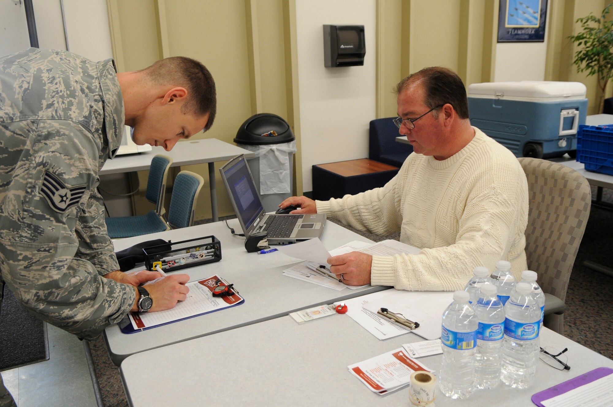 VANDENBERG AIR FORCE BASE, Calif. – Chris Pool, United Blood Services donor recruiter, registers Staff Sgt. Dominic Buzzelli, 30th Security Forces, for the blood drive held at the education center student lounge here Wednesday, Jan. 11, 2012. (U.S. Air Force photo/Tech. Sgt Scottie T. McCord) 