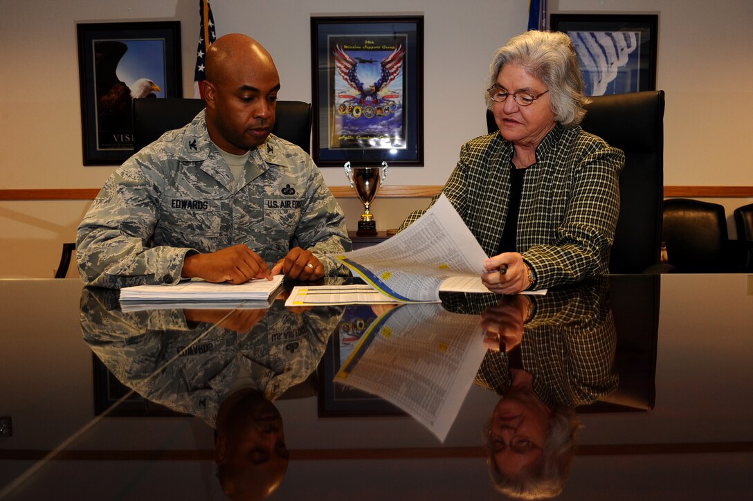 Col. Trent Edwards, 28th Mission Support Group commander, and Ms. Dale Barry, Ellsworth Civilian Personnel Officer, review the information about the second round of voluntary early retirement authority and voluntary separation incentive pay programs that began on Jan. 9. (U.S. Air Force photo by Airman 1st Class Zachary Hada/Released)